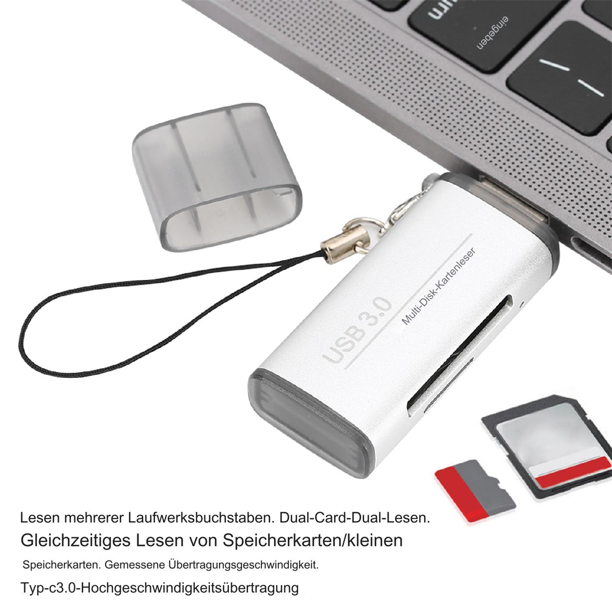 Silberner USB 3.0 Kartenleser mit Karte und grauer Laptop-Tastatur.