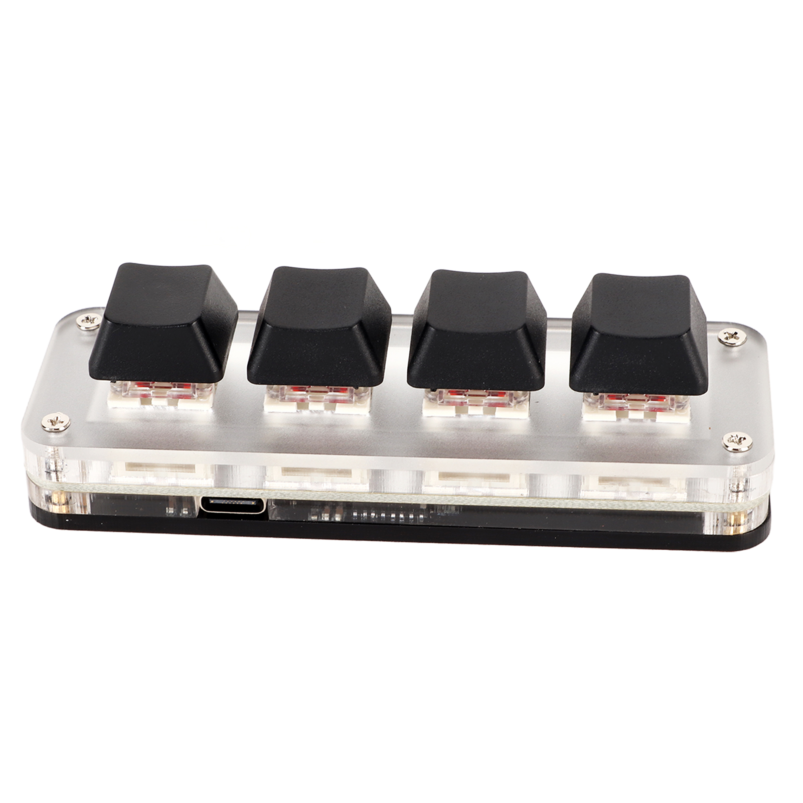 Vier schwarze Tastenkappen auf einer transparenten Acryl-Tastatur. Schrauben sichtbar. USB-Anschluss.