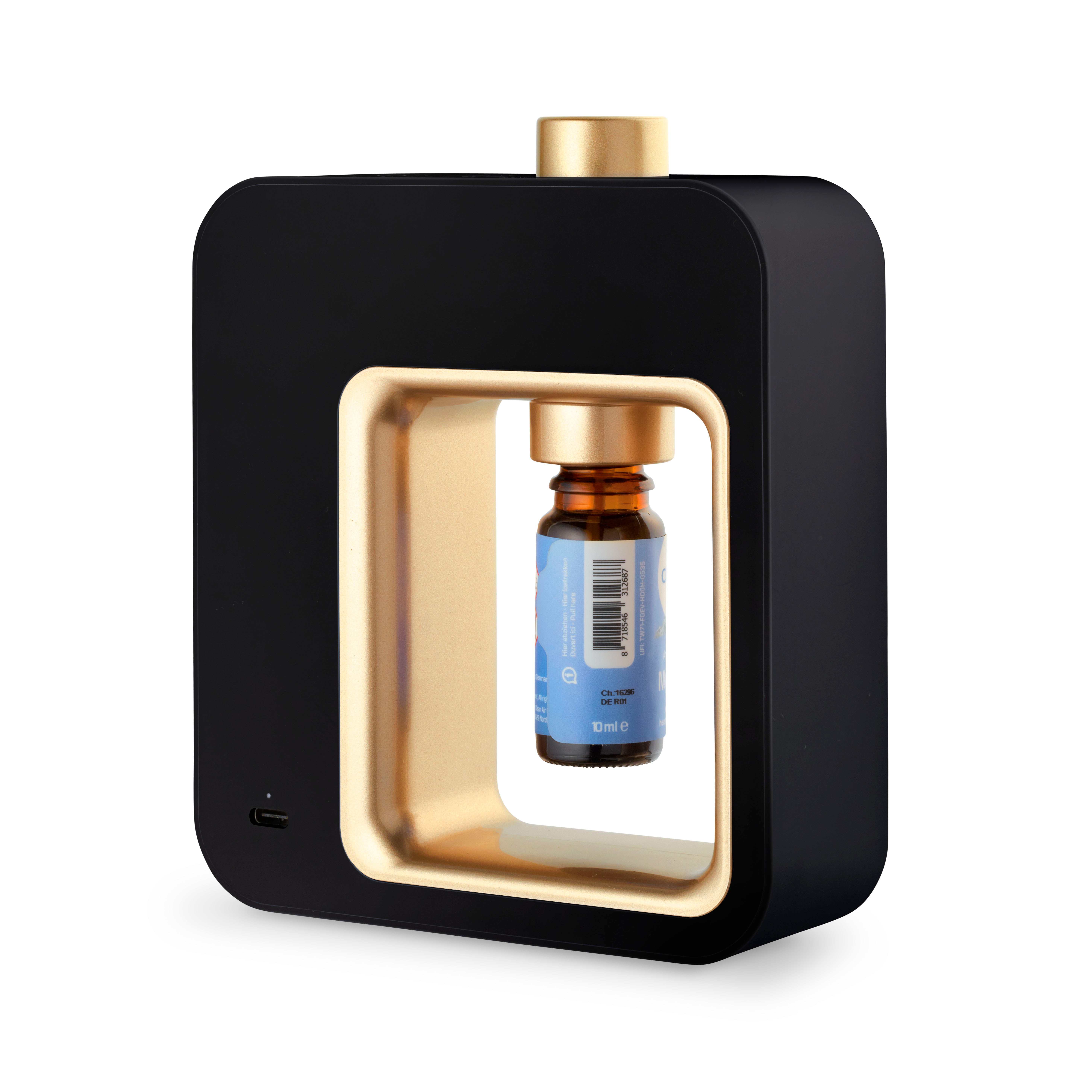 Black and gold essential oil diffuser with a small bottle inside.
