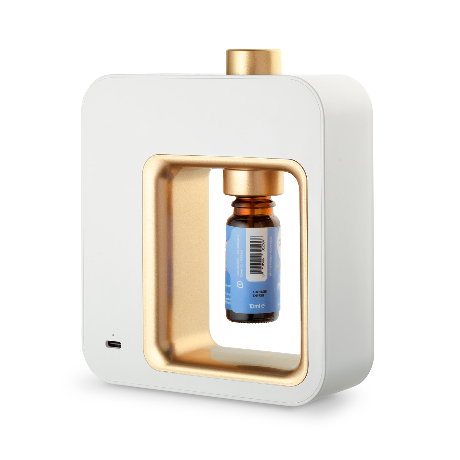 Weißer und goldener ätherischer Öldiffusor mit einer Flasche im Inneren, auf einer weißen Oberfläche.