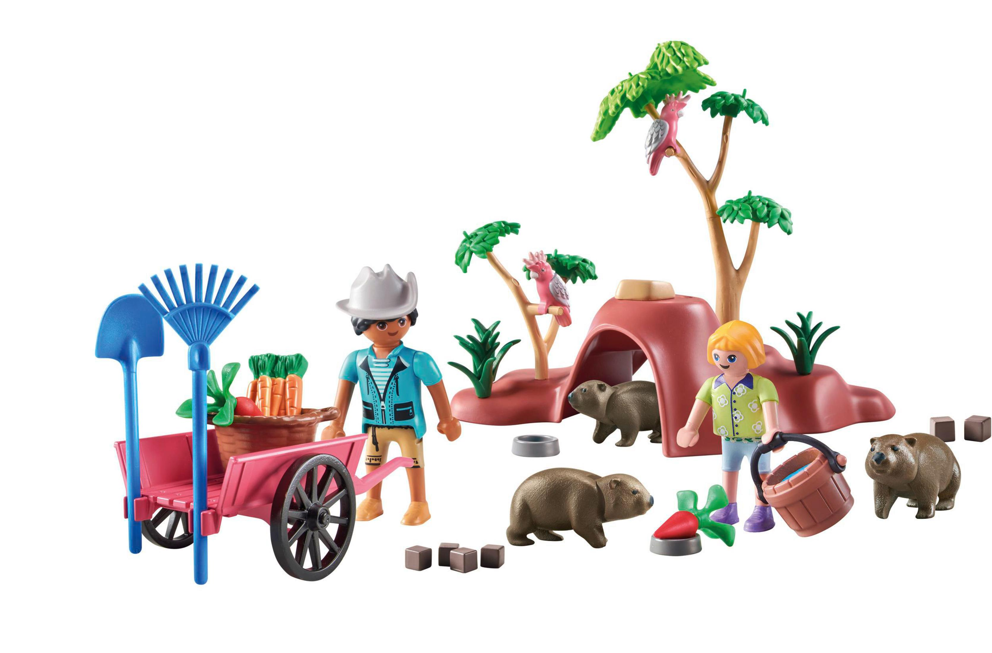 Una scena Playmobil con personaggi, animali, un carrello e un albero.