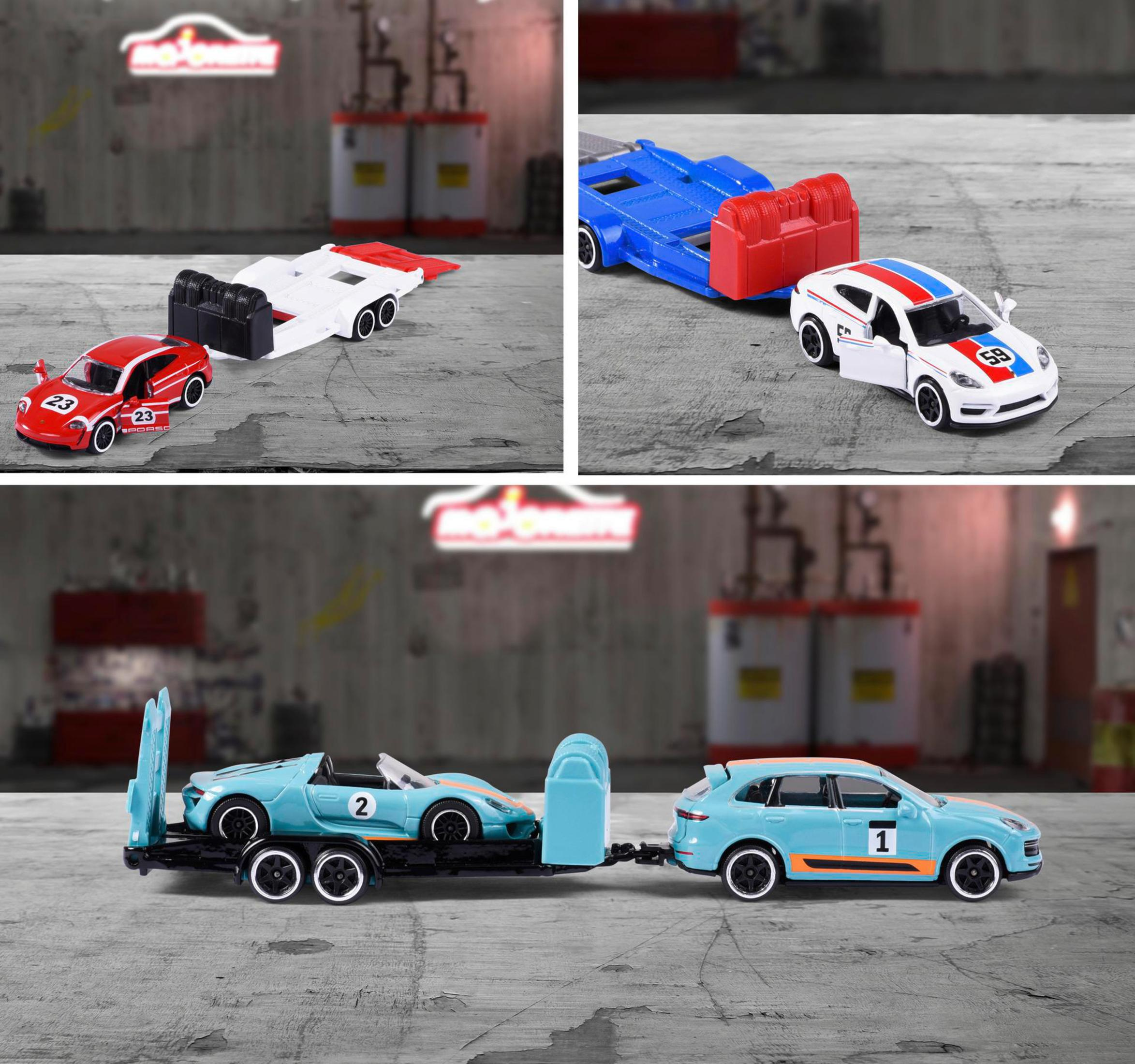 Spielzeugautos auf einem Anhänger, rotes und weißes Auto und blaues und weißes Auto, auf Beton.