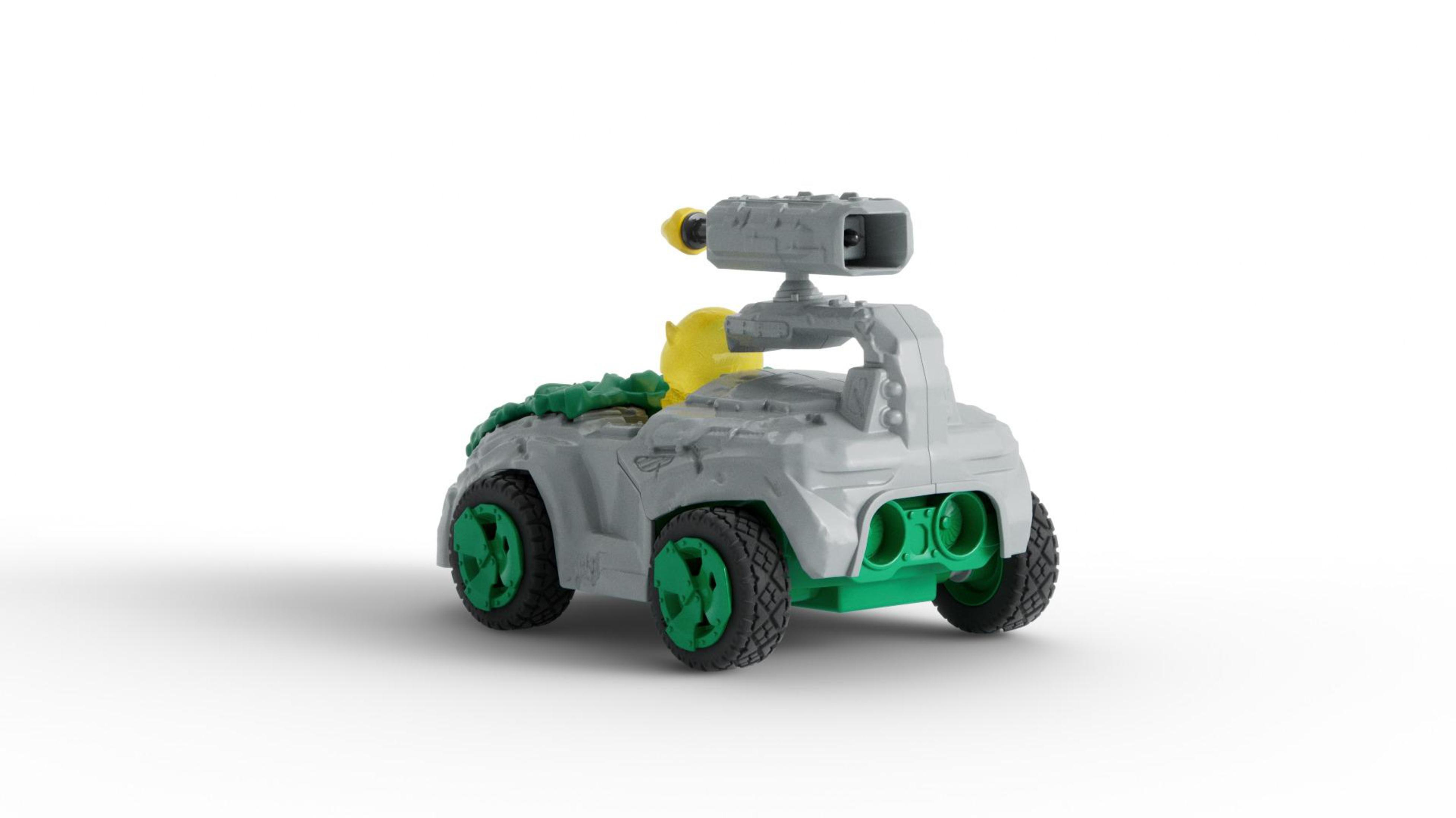Zabawkowy pojazd z szarym nadwoziem i zielonymi kołami. Ma wieżyczkę na górze.