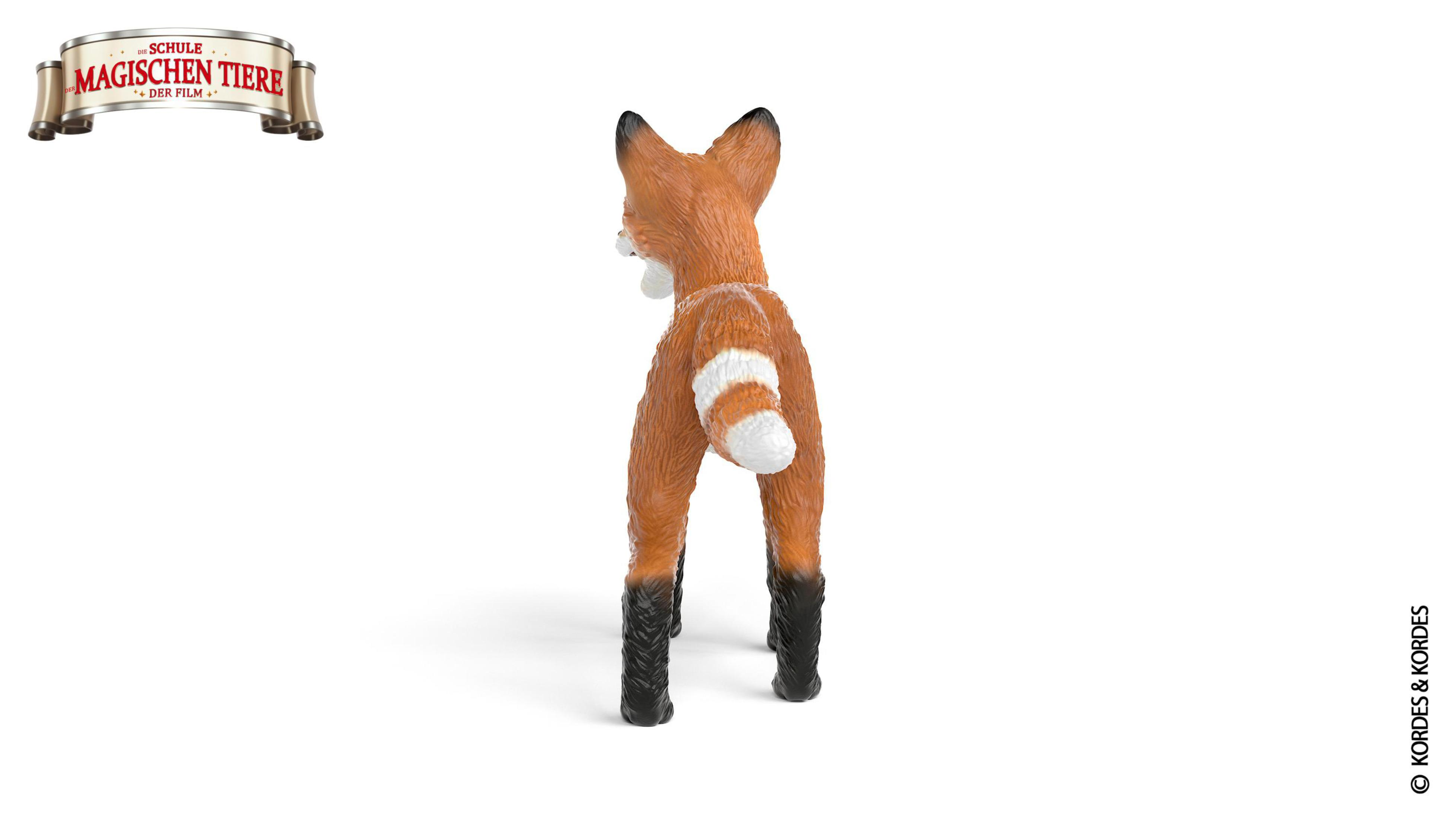 Pomarańczowa zabawka lisa, widok z tyłu, białe tło, tytuł filmu.