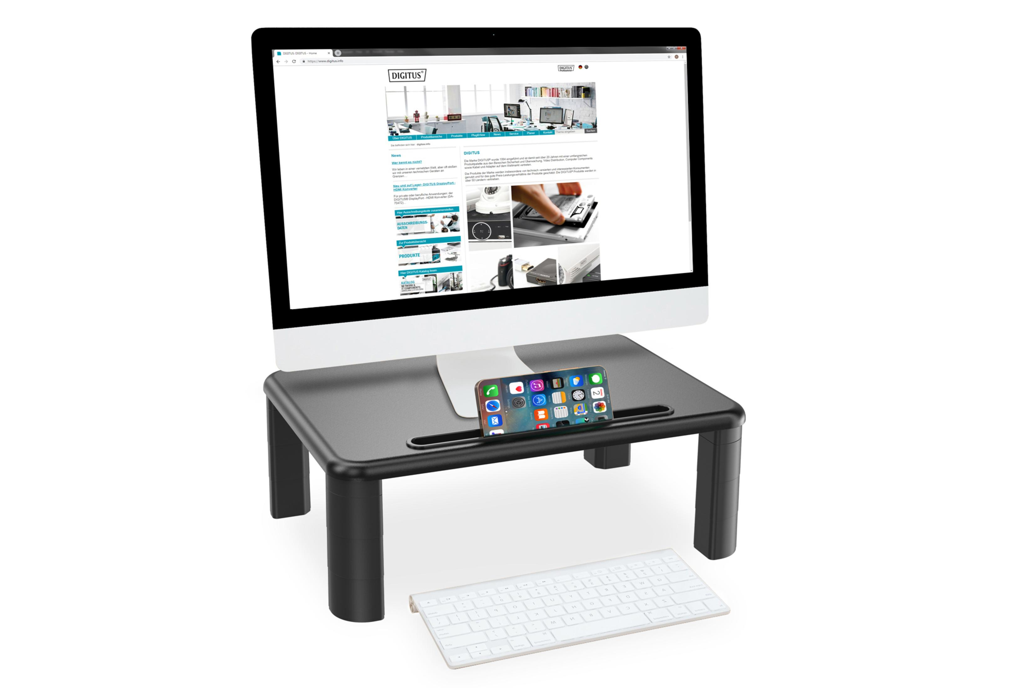 Schwarzer Schreibtischaufsatz mit Monitor, Telefon und Tastatur. Der Monitor zeigt eine Website, das Telefon App-Symbole.
