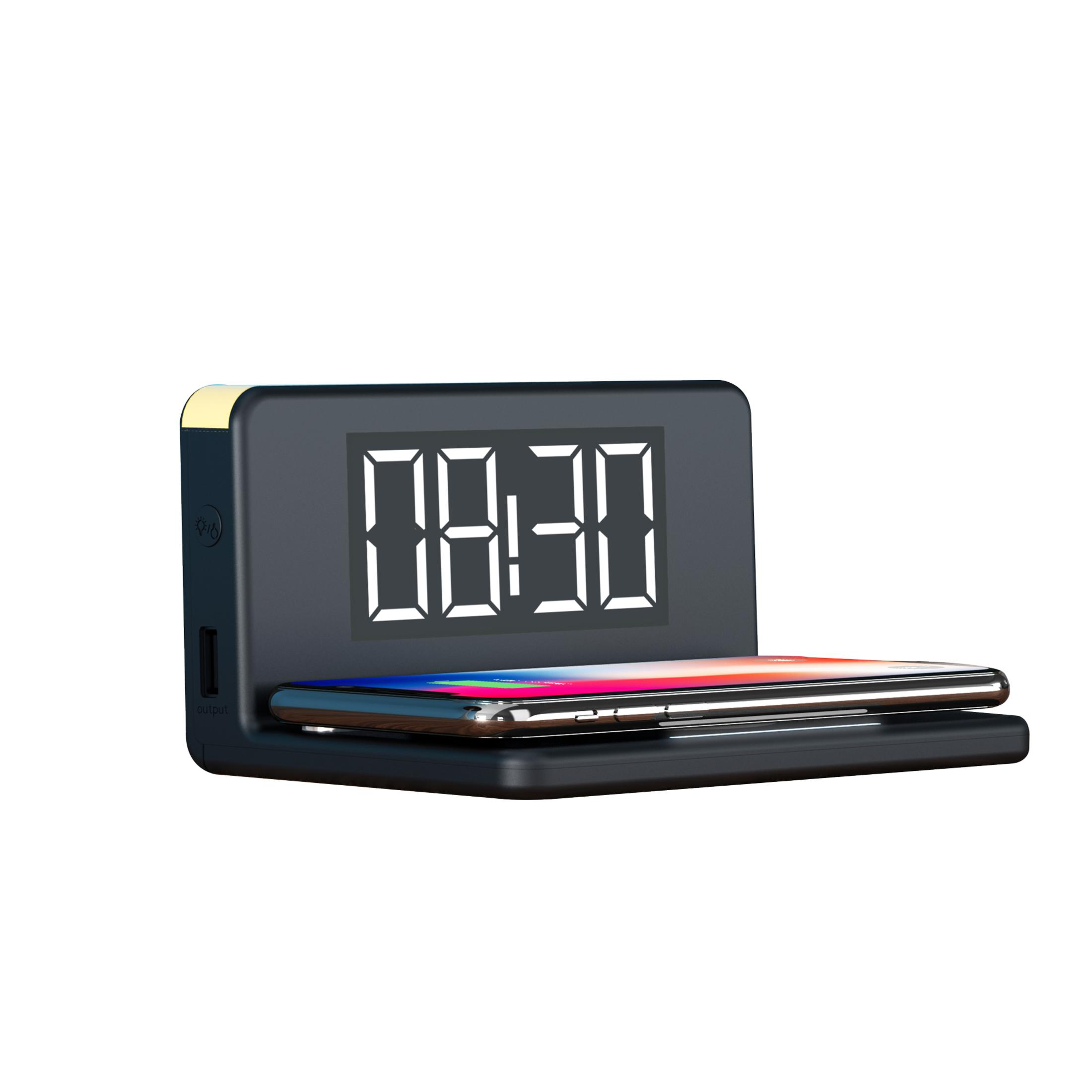 Schwarze Uhr, die 08:30 anzeigt, mit einem Telefon oben drauf.