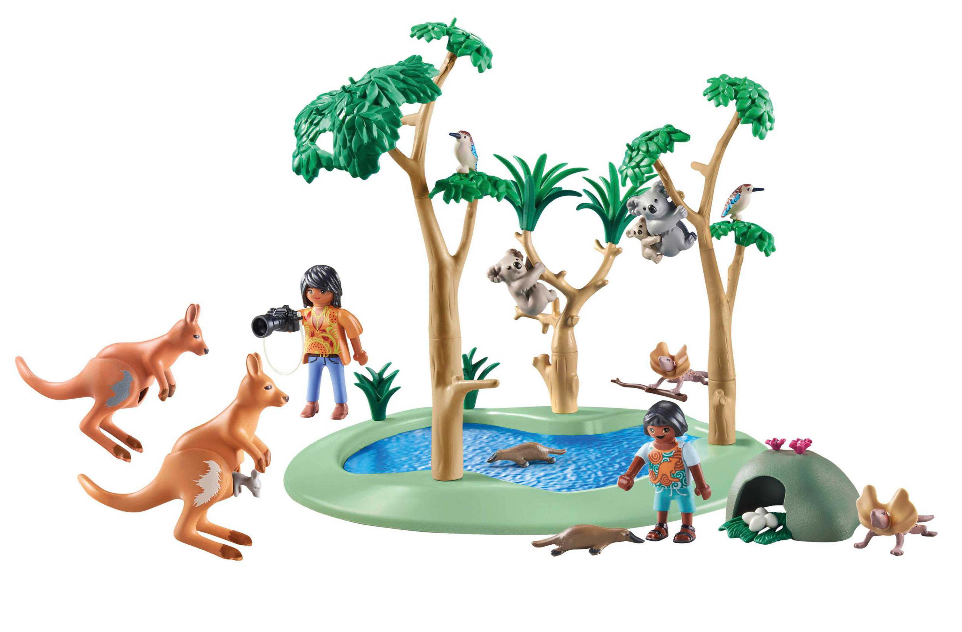 Scena zoo Playmobil con canguri, koala e persone. Sono presenti alberi verdi, acqua e una grotta.