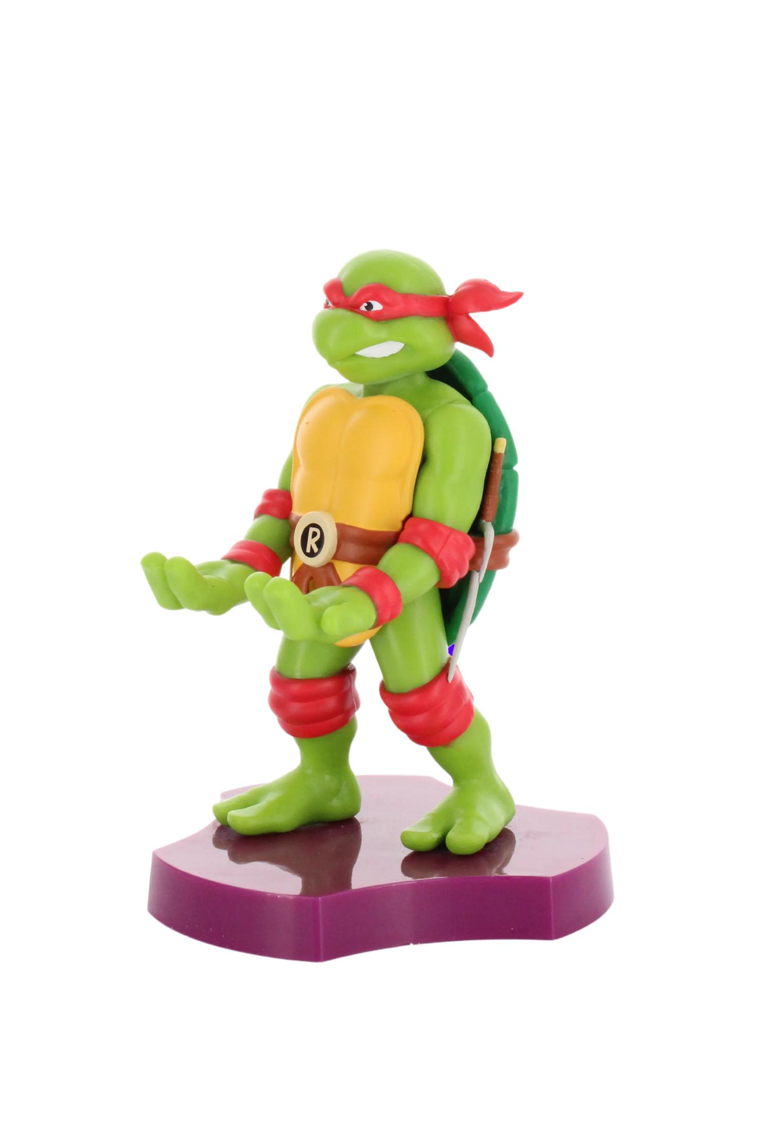 Figura di Raffaello delle Tartarughe Ninja. Tartaruga verde con maschera e braccia rosse su base viola.