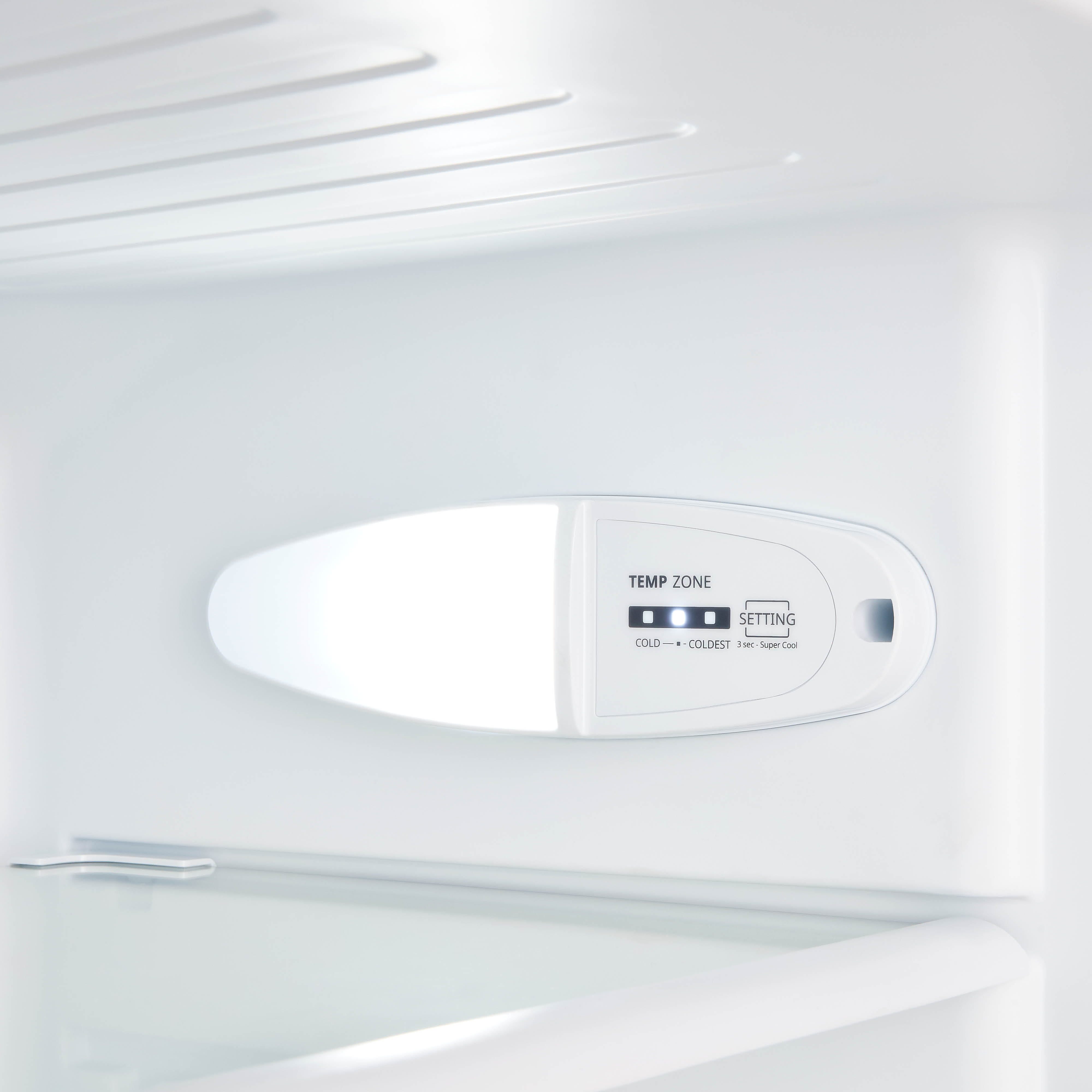 Inside a white refrigerator, a white control panel displays temperature settings and lights.