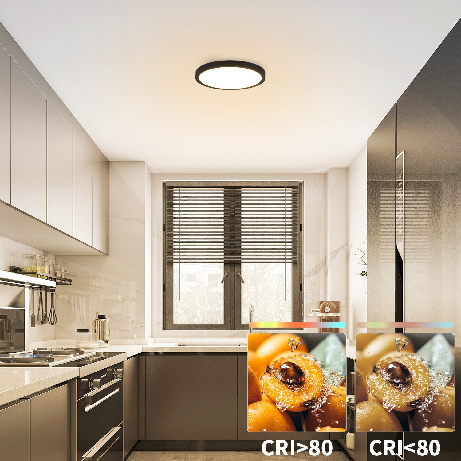 Cucina con luce a soffitto. Grafica di frutta accanto alla luce. Armadi e elettrodomestici visibili.