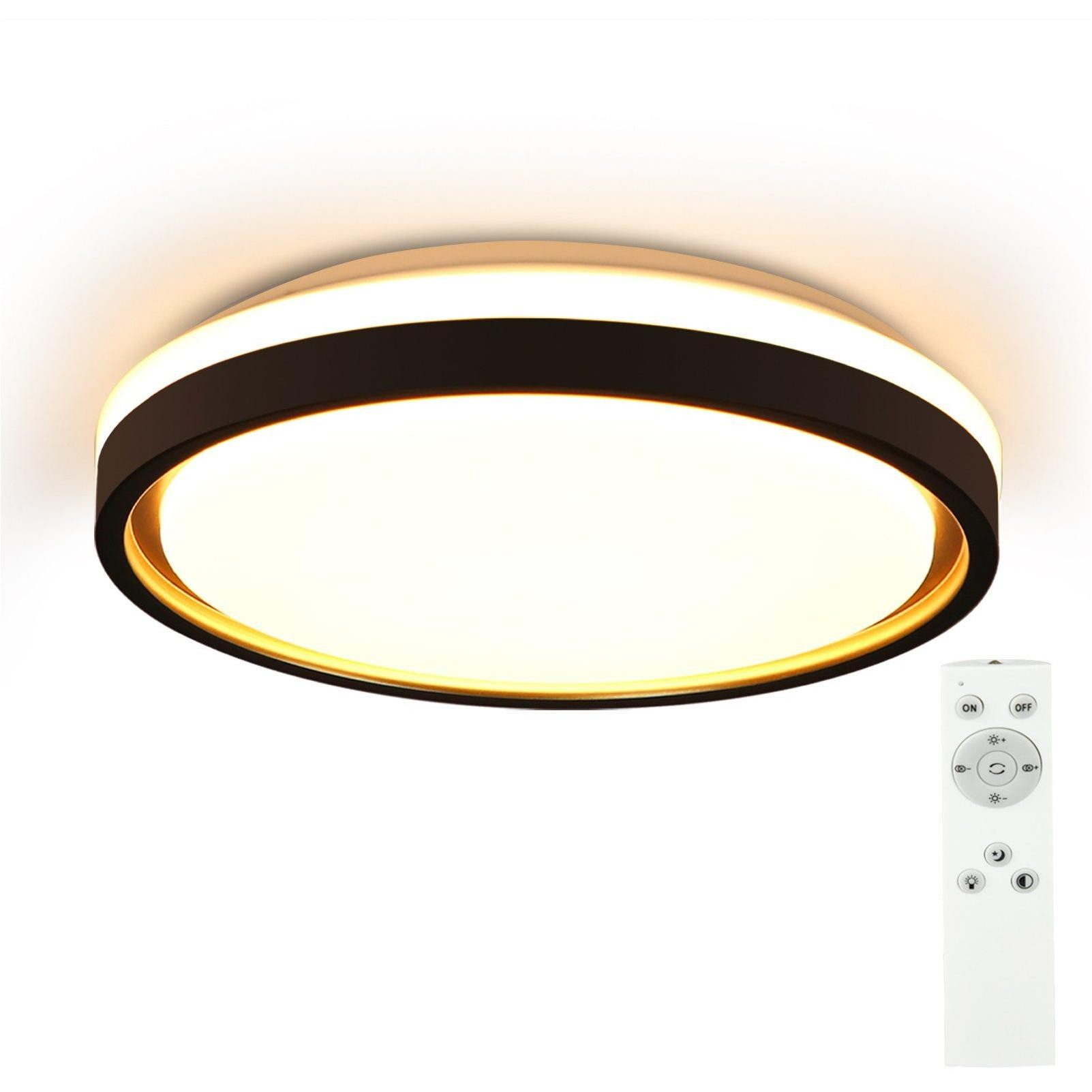 Okrągła lampa sufitowa. Ma białą i czarną kolorystykę. Pilot po prawej stronie.