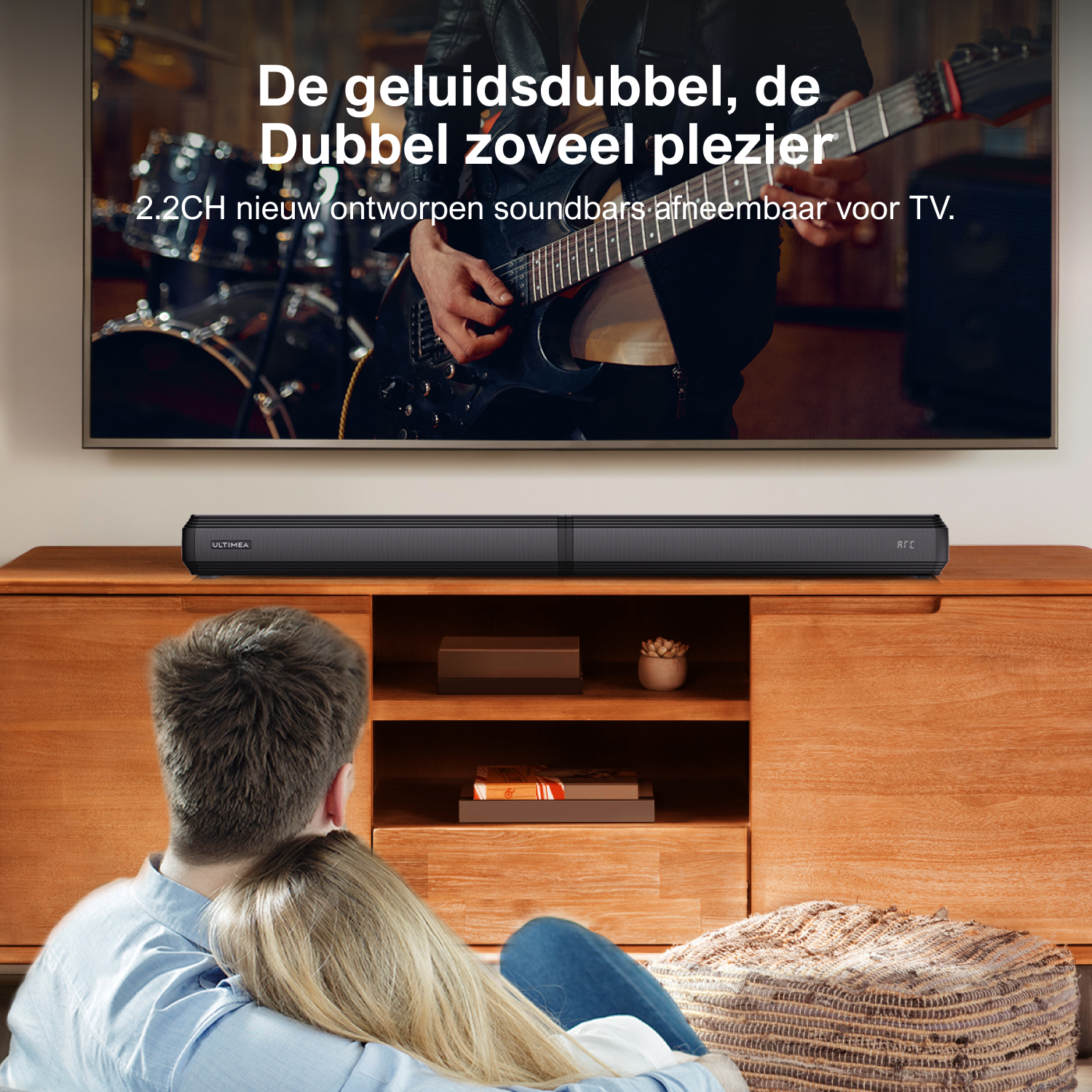 Couple watching TV with a soundbar on a wooden cabinet, and a large TV.