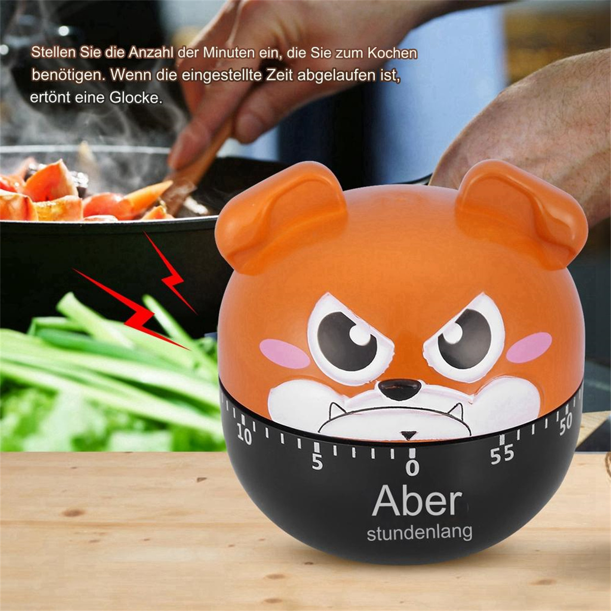 Ein Timer in Form eines Hundes mit schwarzem Sockel, auf ein paar Minuten eingestellt. Im Hintergrund kocht eine Person.