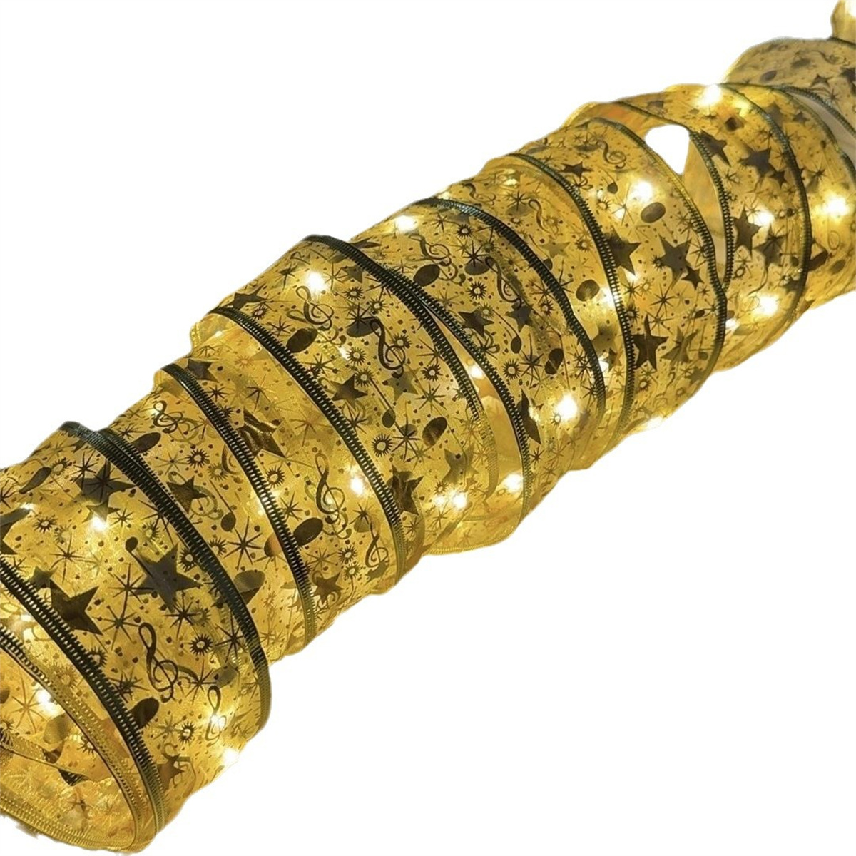 Ein goldenes Band mit Lichtern, Noten und Sternen.