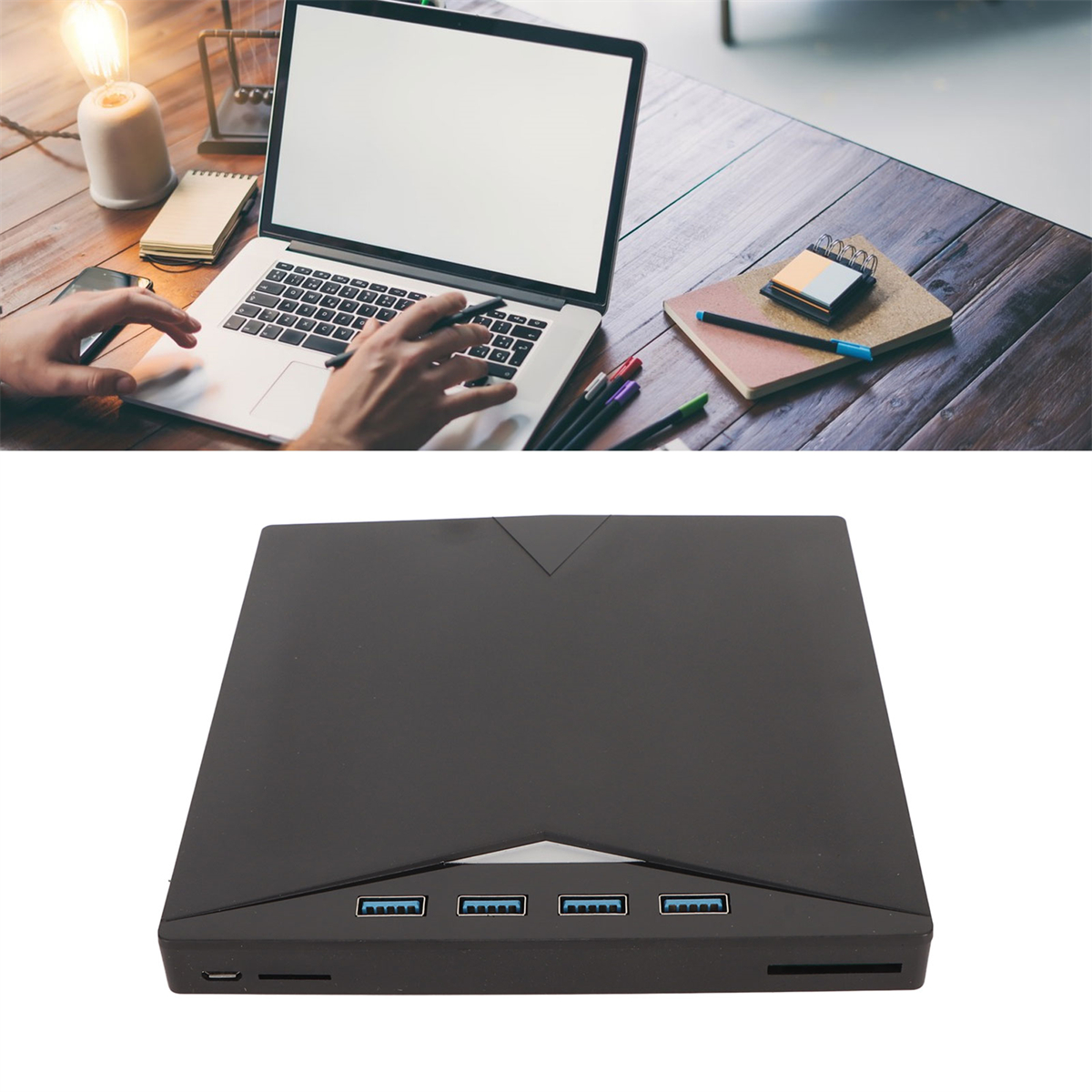 Laptop und ein schwarzes Gerät auf einem Tisch. Das Gerät hat USB-Anschlüsse.