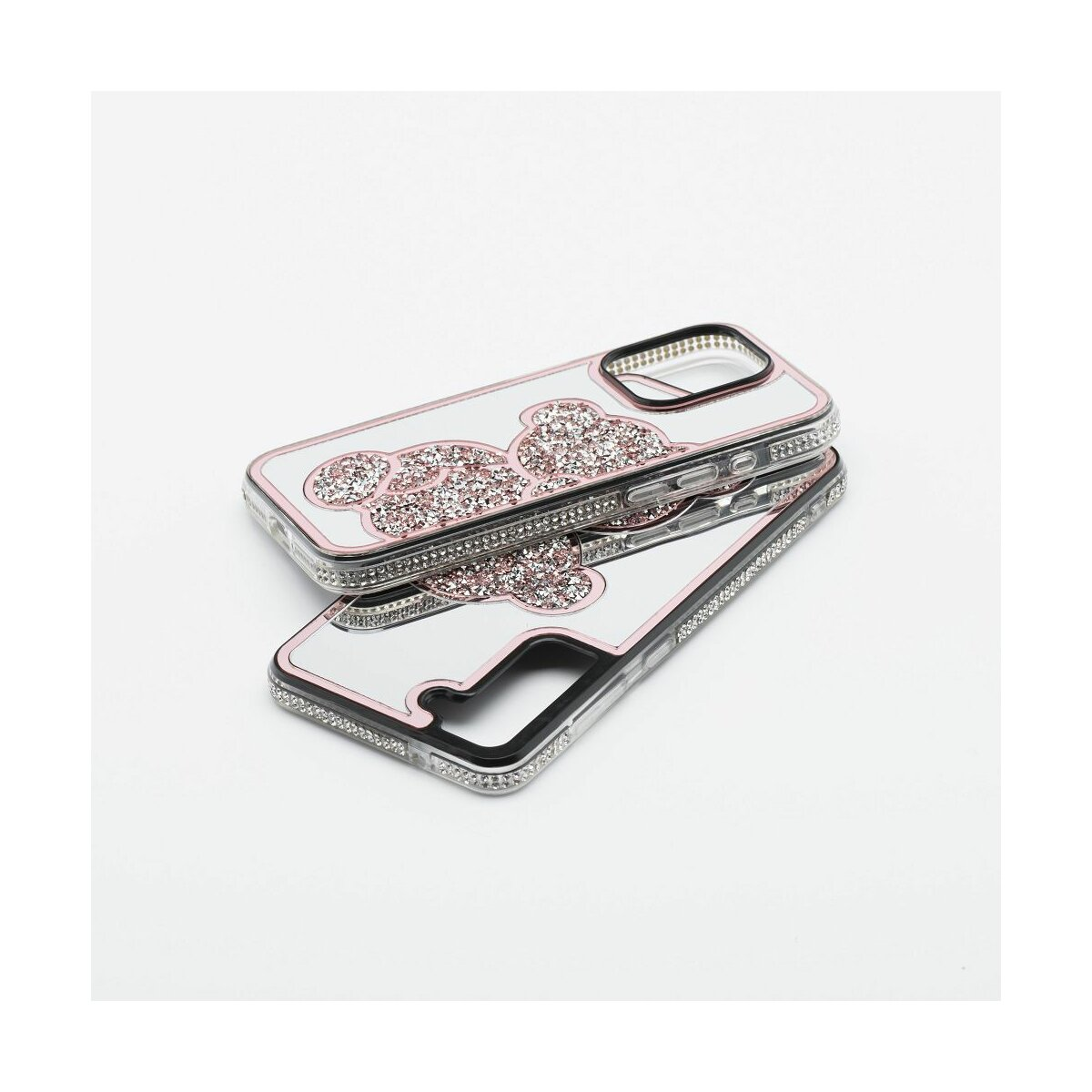 Due custodie per telefono con glitter rosa e un design su sfondo bianco.