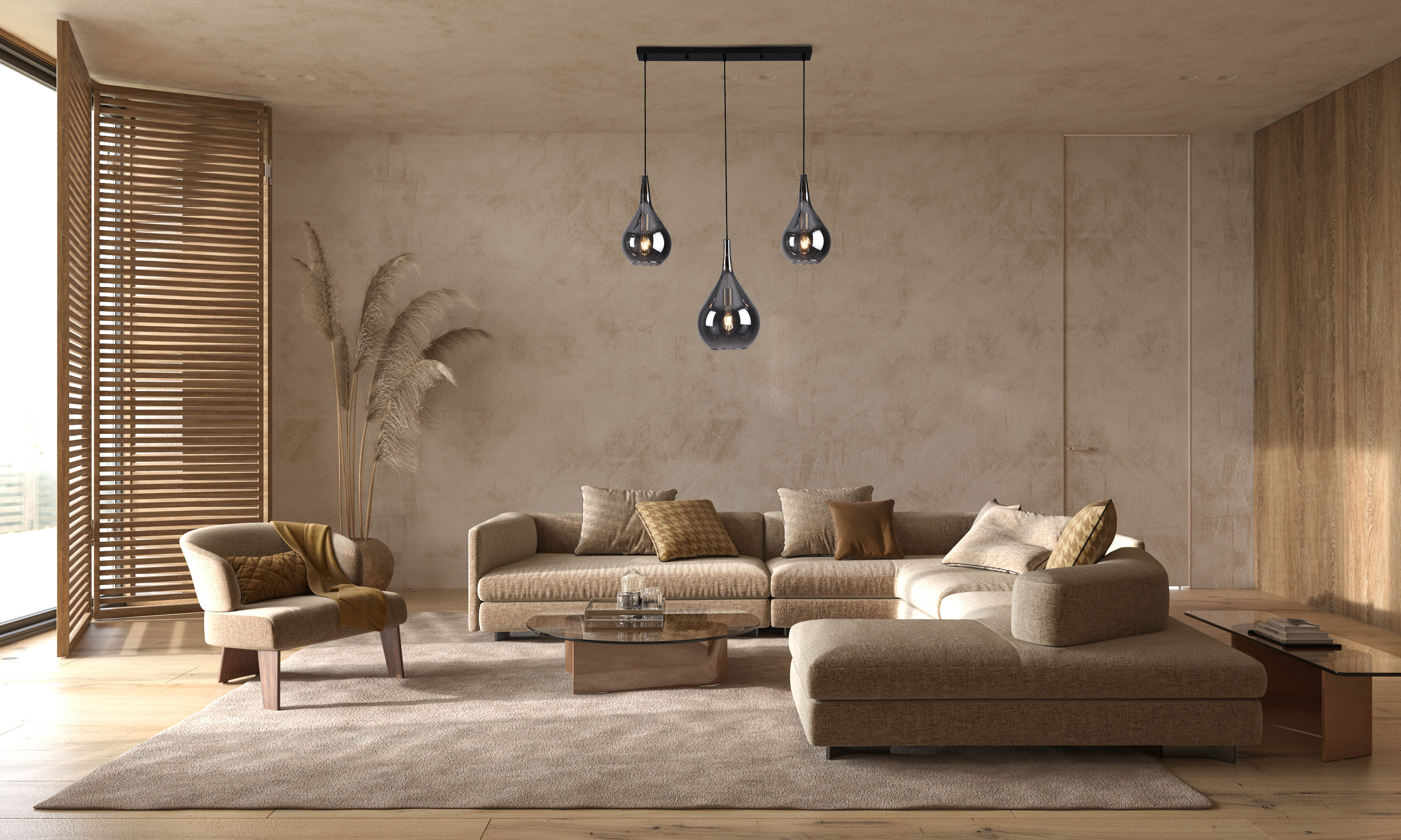Wohnzimmer mit drei Hängeleuchten, Sofa, Stuhl und Couchtisch.