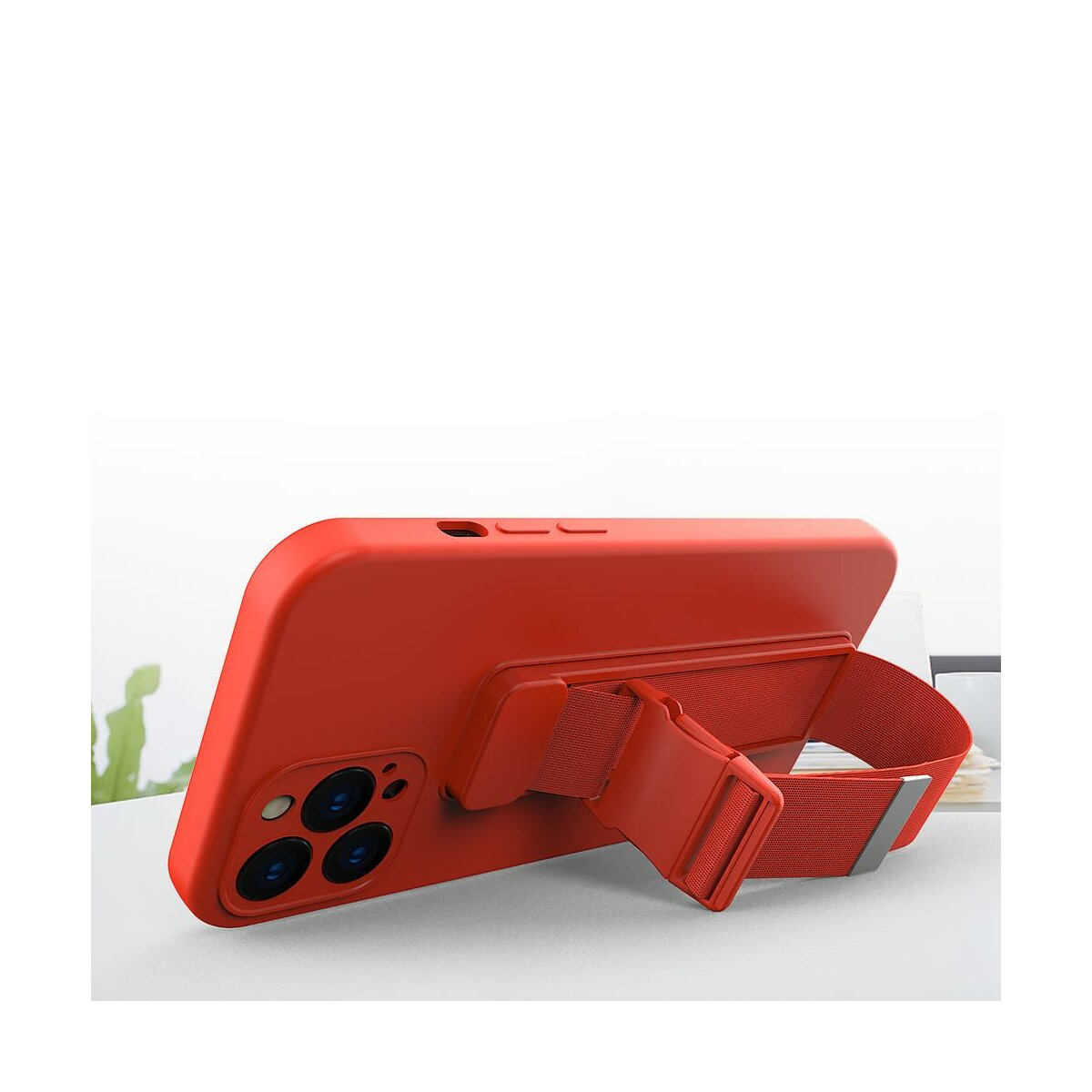 Rote Handyhülle mit Riemen. Das Telefon liegt auf einer weißen Oberfläche. Weißer Hintergrund.