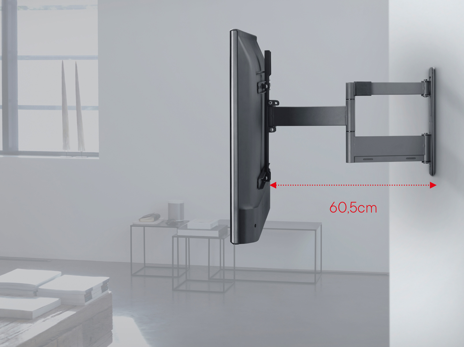 A TV mounted on a wall with a distance of 60.5 cm indicated from the wall.