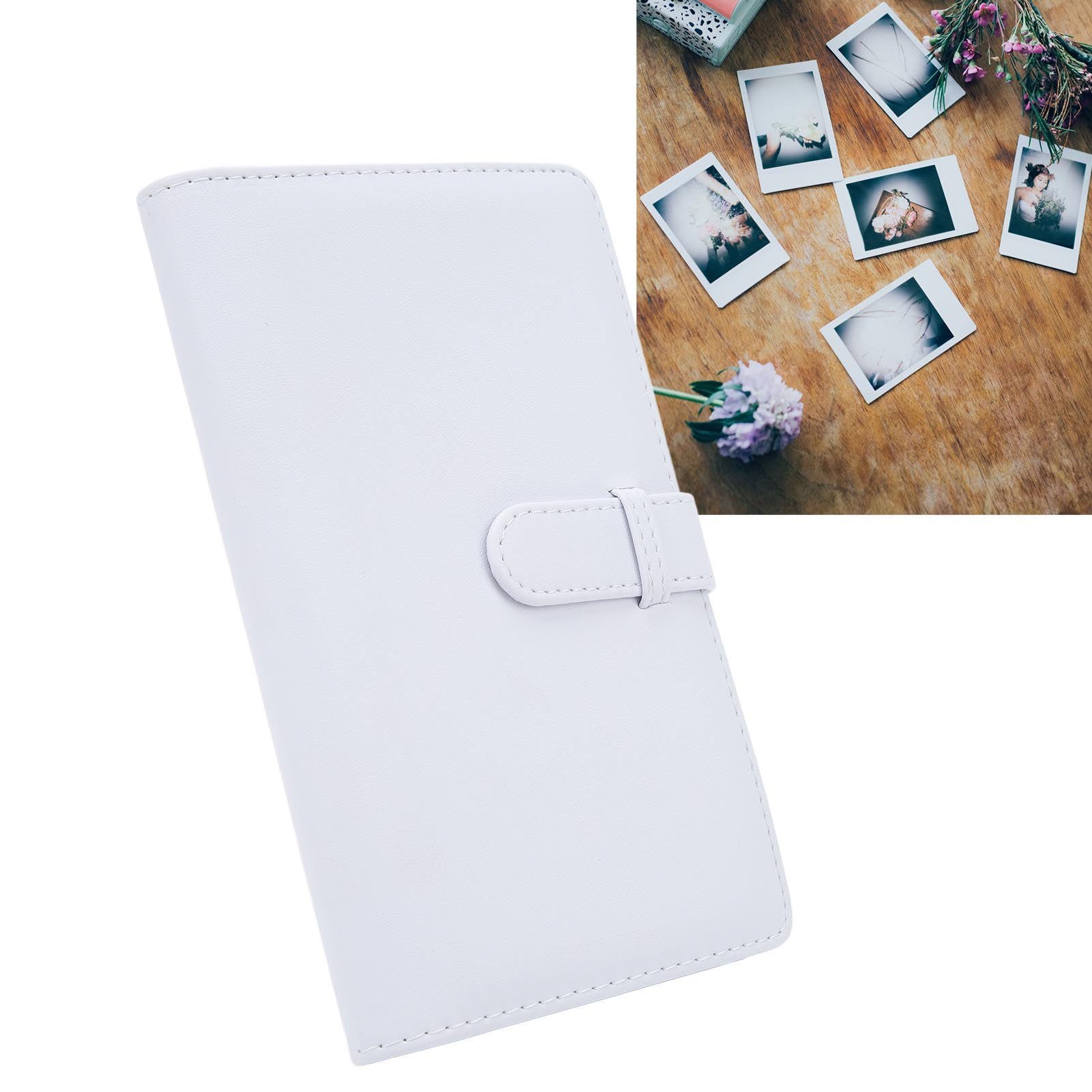 Ein weißes Fotoalbum mit Verschluss, mit Polaroids und Blumen drumherum.
