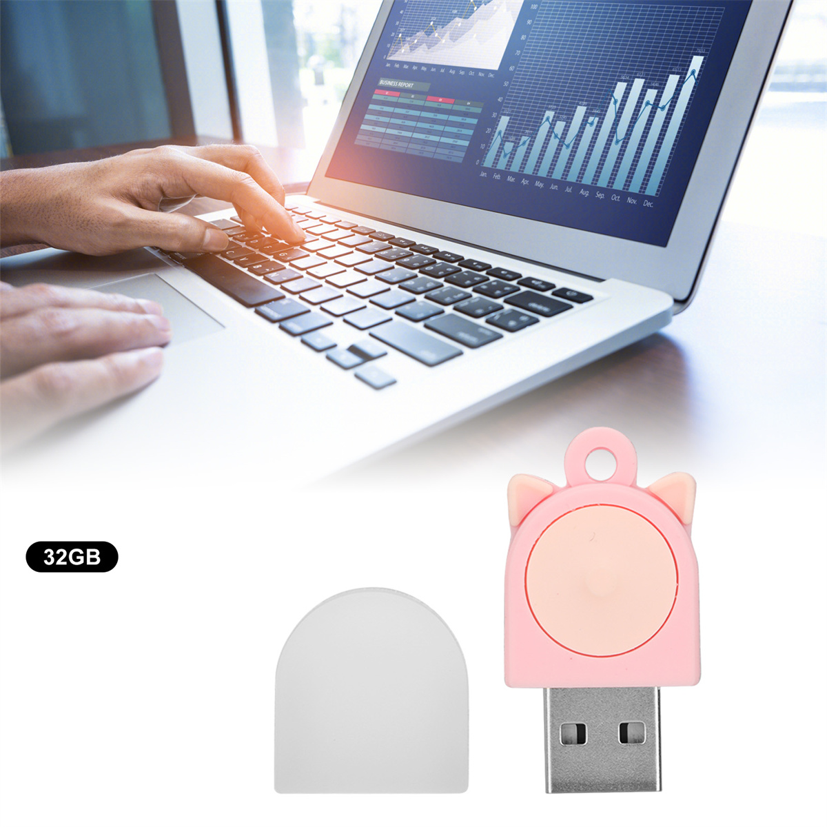 Ein Laptop und ein rosa Katzen-USB-Stick liegen auf dem Tisch. Eine Hand bedient den Laptop.