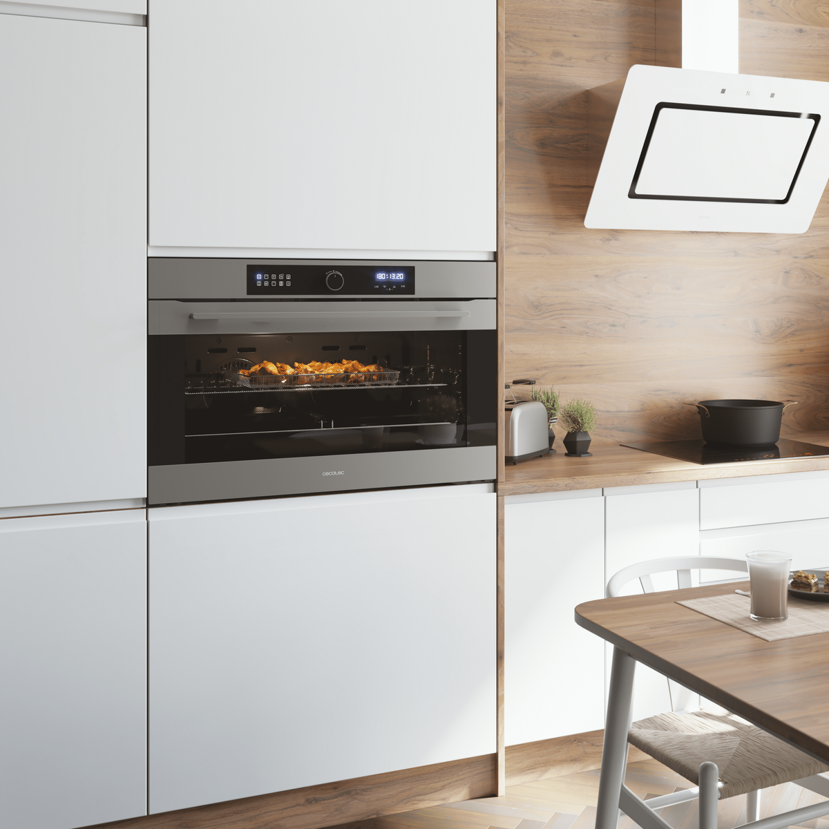 Una cocina moderna con horno, campana extractora y zona de comedor. El horno está abierto con comida dentro.