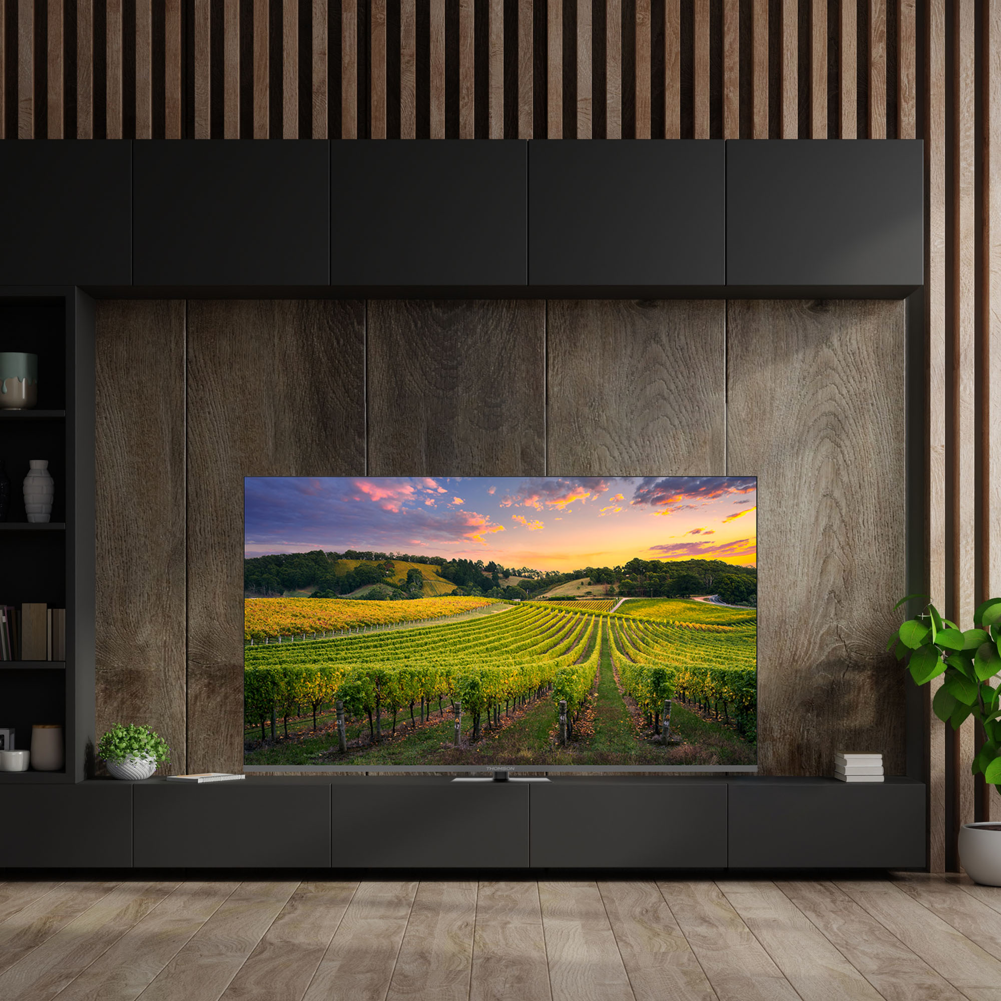 Un soggiorno moderno con una TV che mostra un paesaggio di vigneti al tramonto.