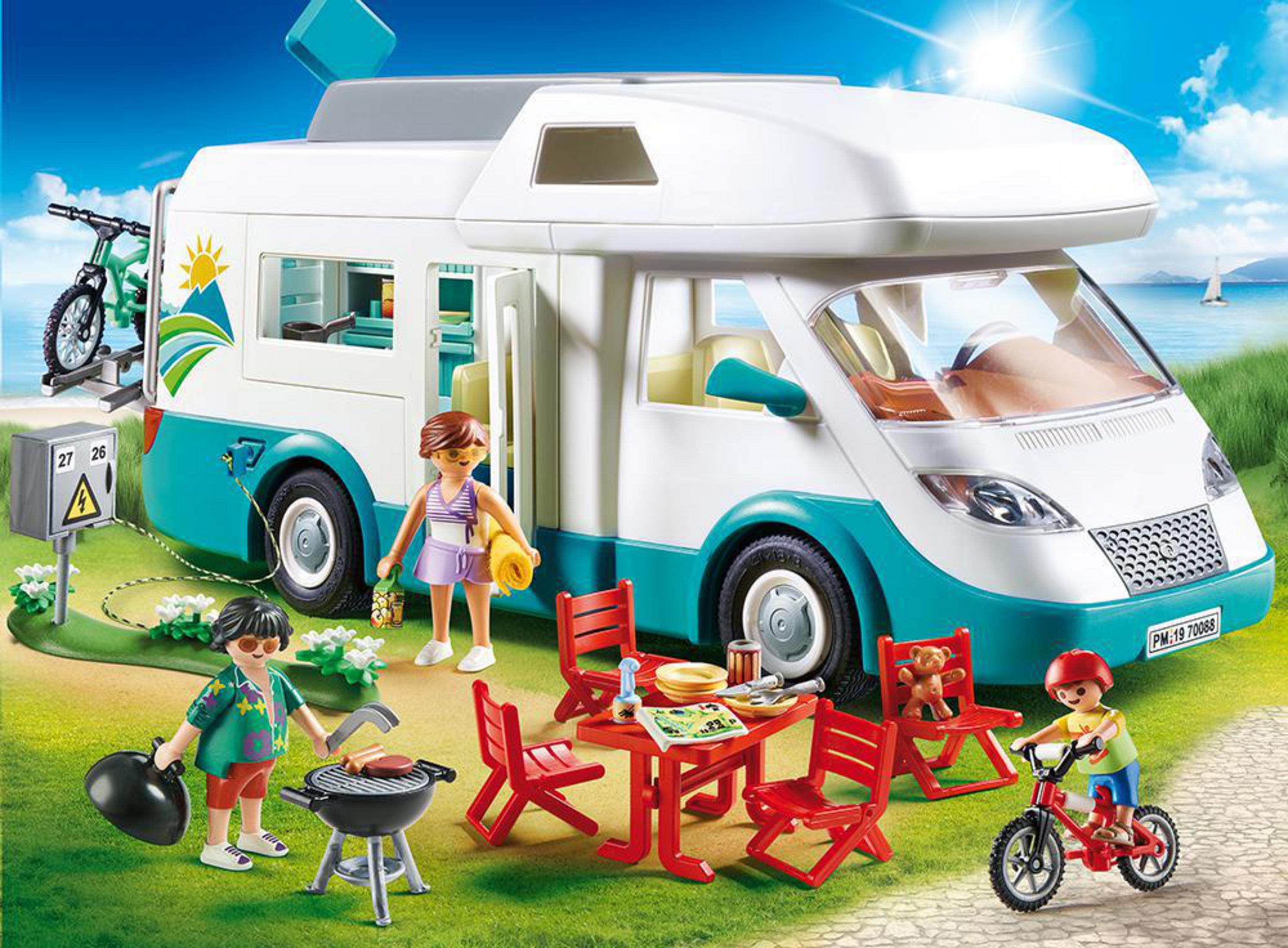 Scena z kamperem Playmobil z figurkami i akcesoriami w słoneczny dzień.