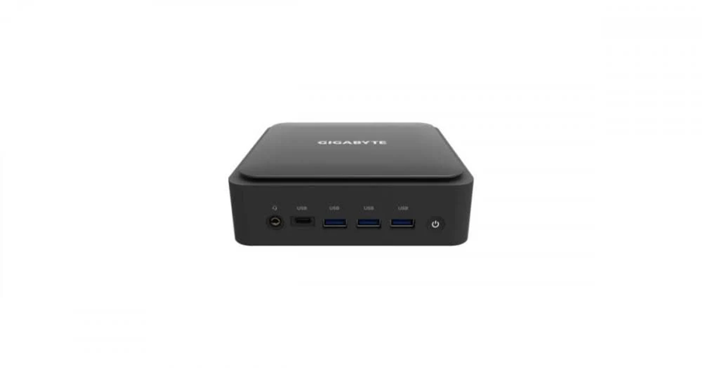 Una pequeña computadora GIGABYTE negra con múltiples puertos USB, que ofrece un diseño compacto y moderno.