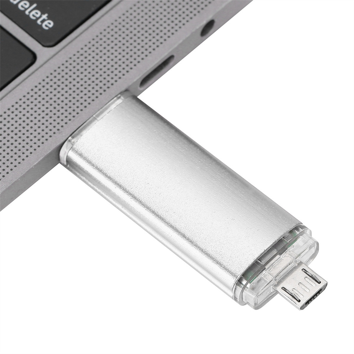 Silberner USB-Stick, der an einen Laptop angeschlossen ist. Der Stick hat einen Micro-USB-Anschluss.