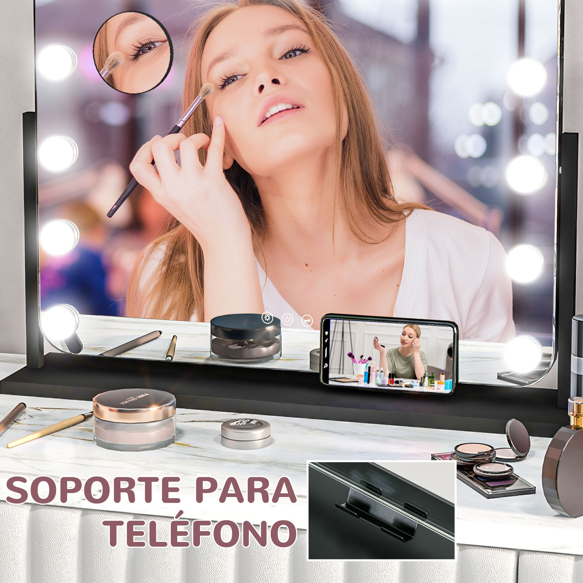 Una mujer maquillándose frente a un espejo con luces y un teléfono que muestra un video.