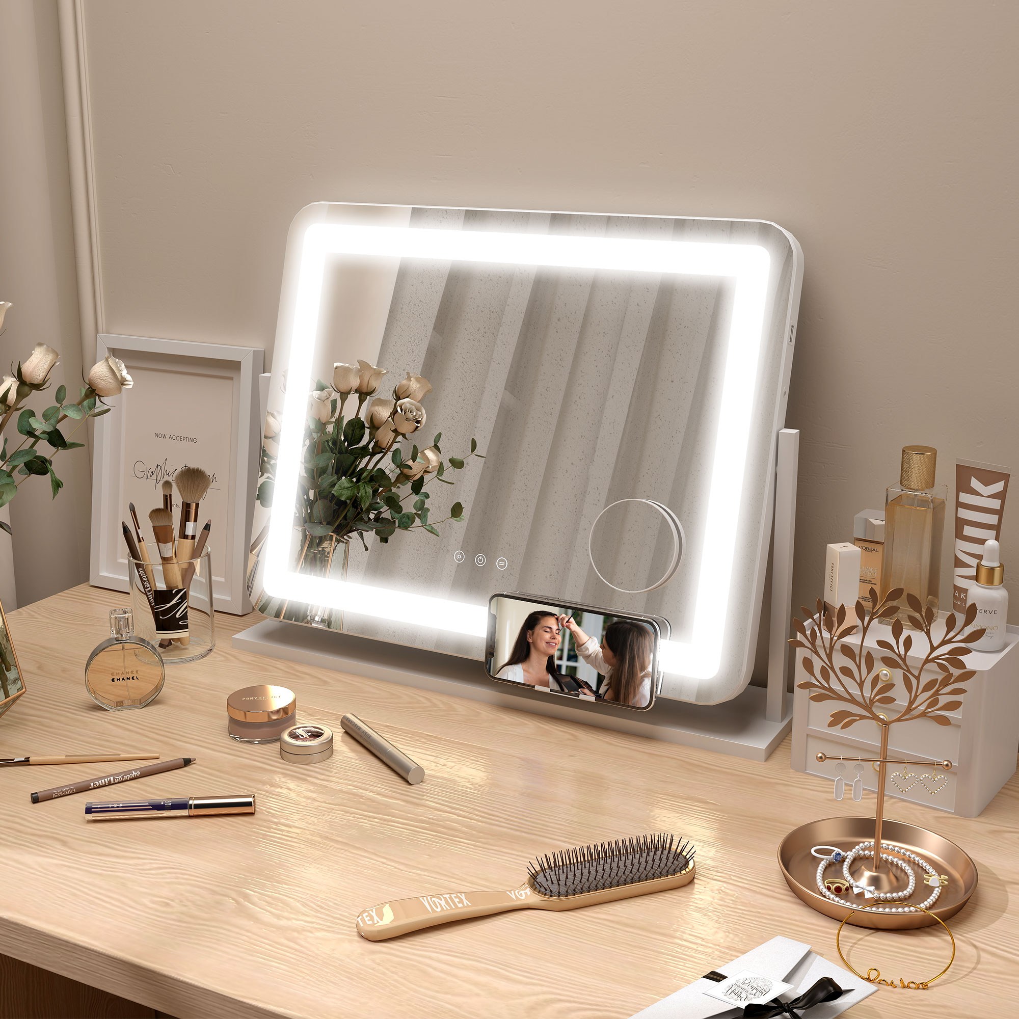 Un espejo de maquillaje iluminado con accesorios en una mesa de madera, un teléfono está montado.