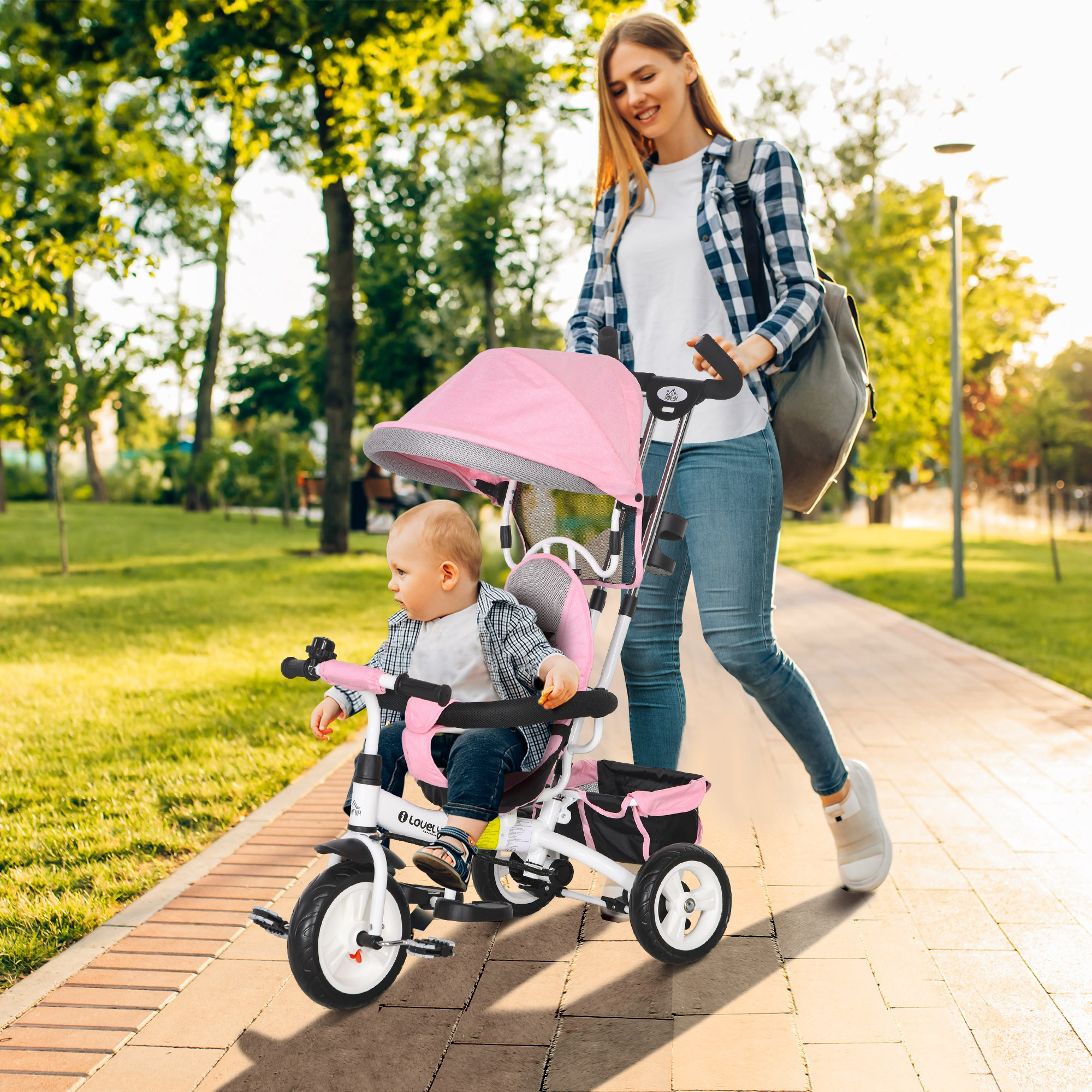 Una donna che spinge un passeggino rosa con un bambino in un parco. La donna indossa una camicia a quadri.