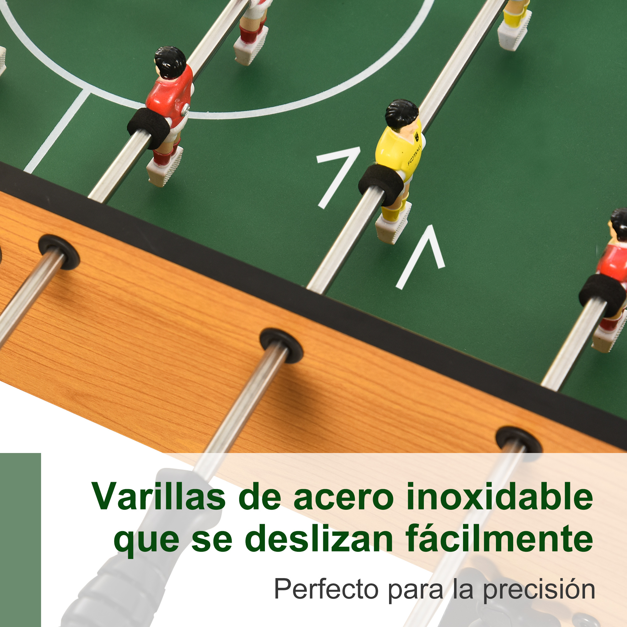 Una mesa de futbolín con jugadores en rojo y amarillo, con texto sobre las barras de acero.