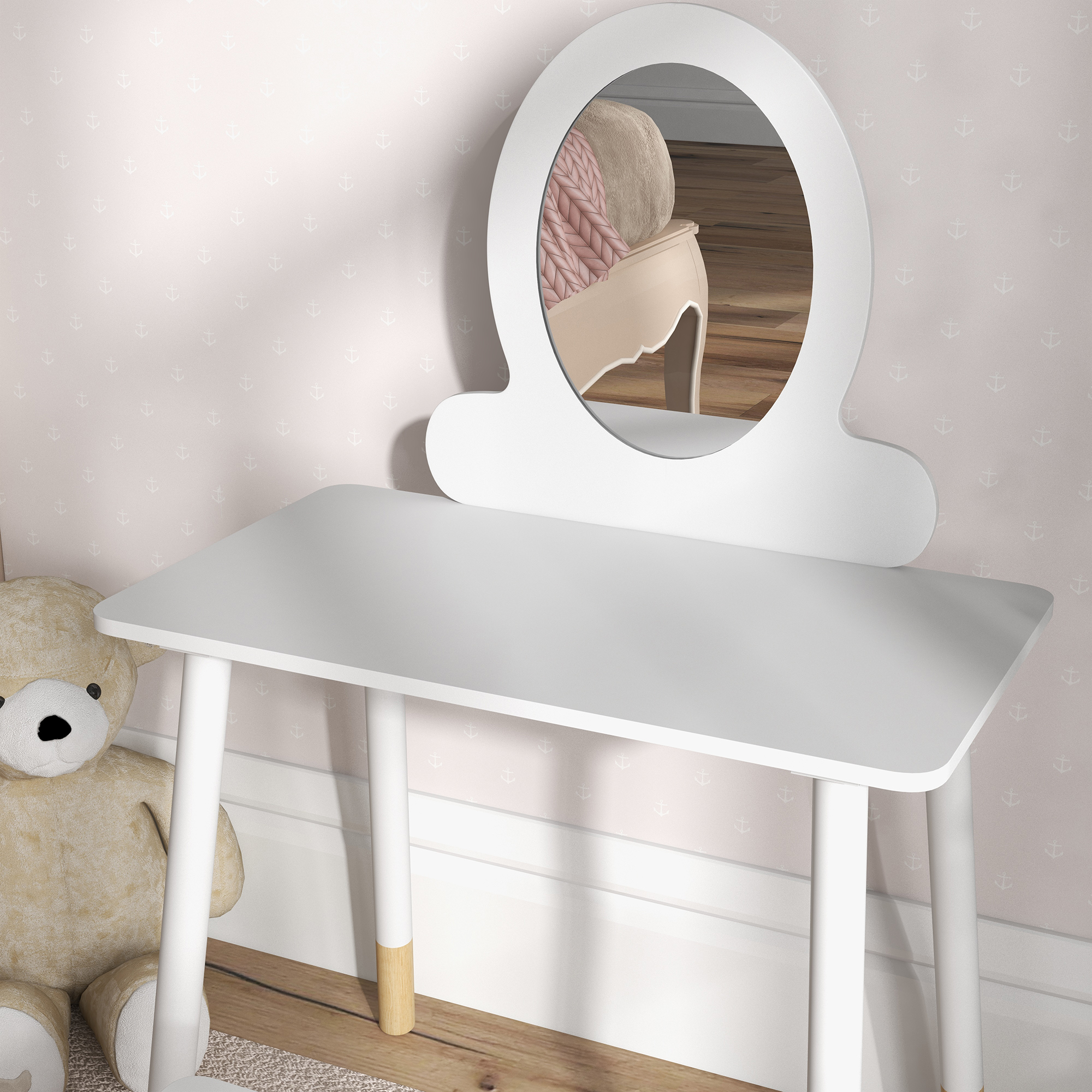 Tocador blanco con espejo ovalado, un oso de peluche y una pared rosa con patrones de anclas.