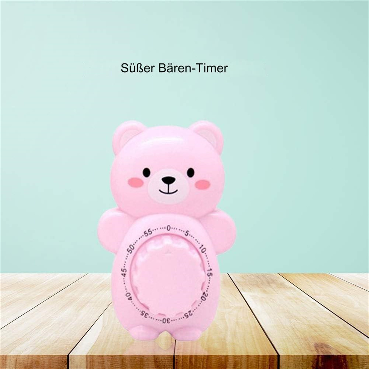 Ein rosafarbener Bären-Timer auf Holz. Er hat ein Zifferblatt mit Zahlen und ein süßes Gesicht.