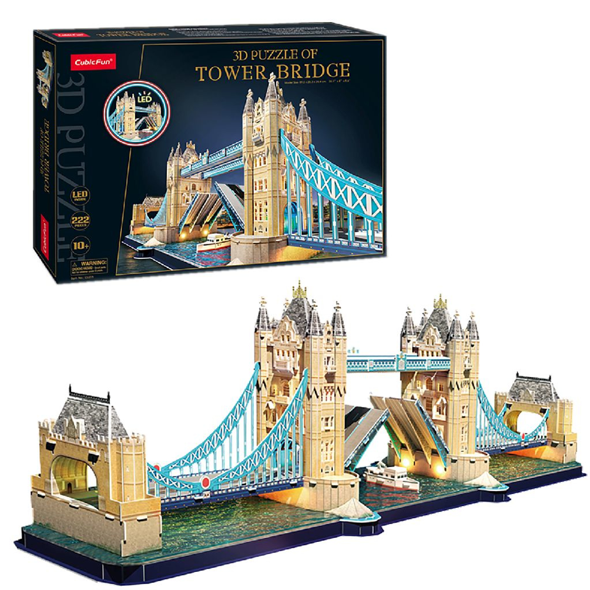 Pudełko z puzzlami 3D i złożony model Tower Bridge z ciemnoniebieską podstawą i światłami.