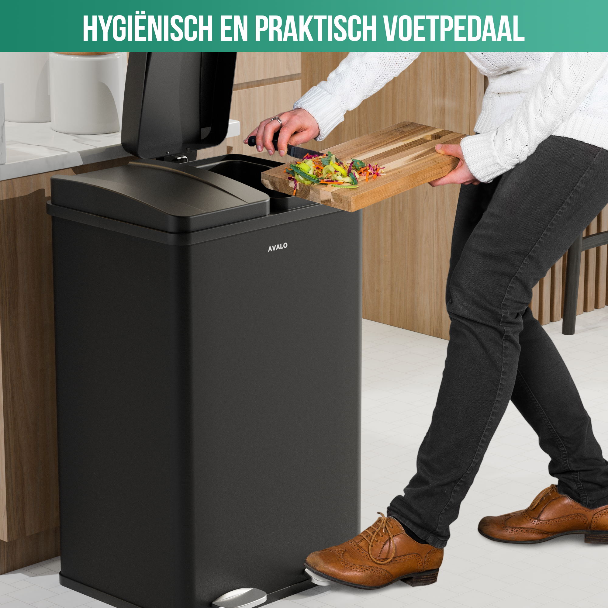 A person is putting food waste into a black trash can. The trash can has a foot pedal.