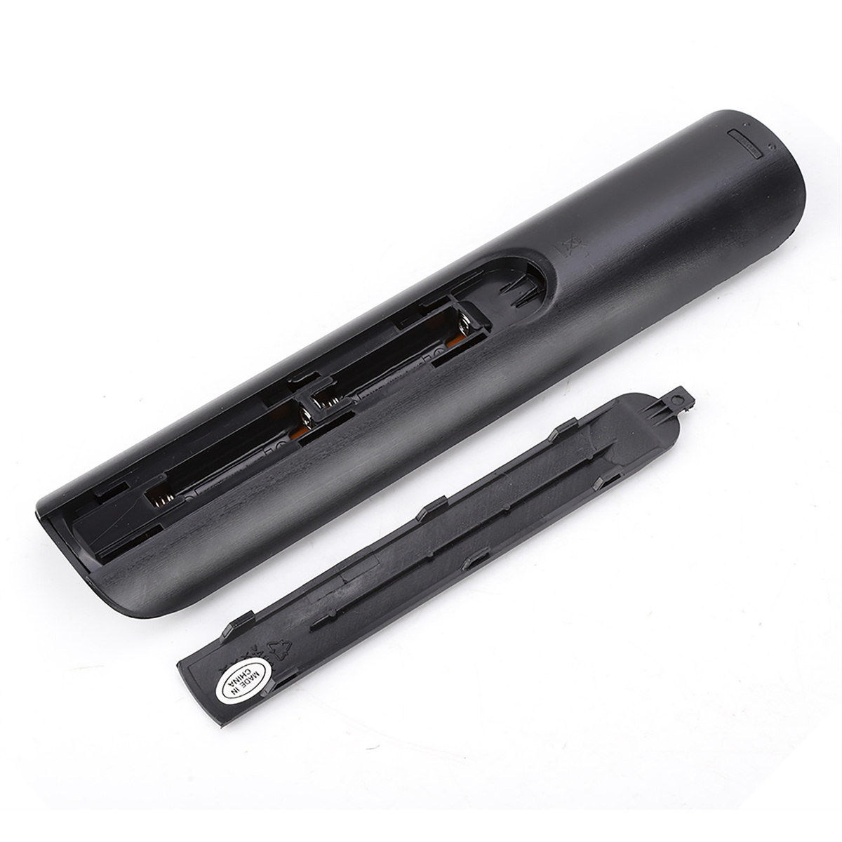 Die Rückseite einer schwarzen Fernbedienung mit geöffnetem Batteriefach, das die Batteriesteckplätze zeigt.