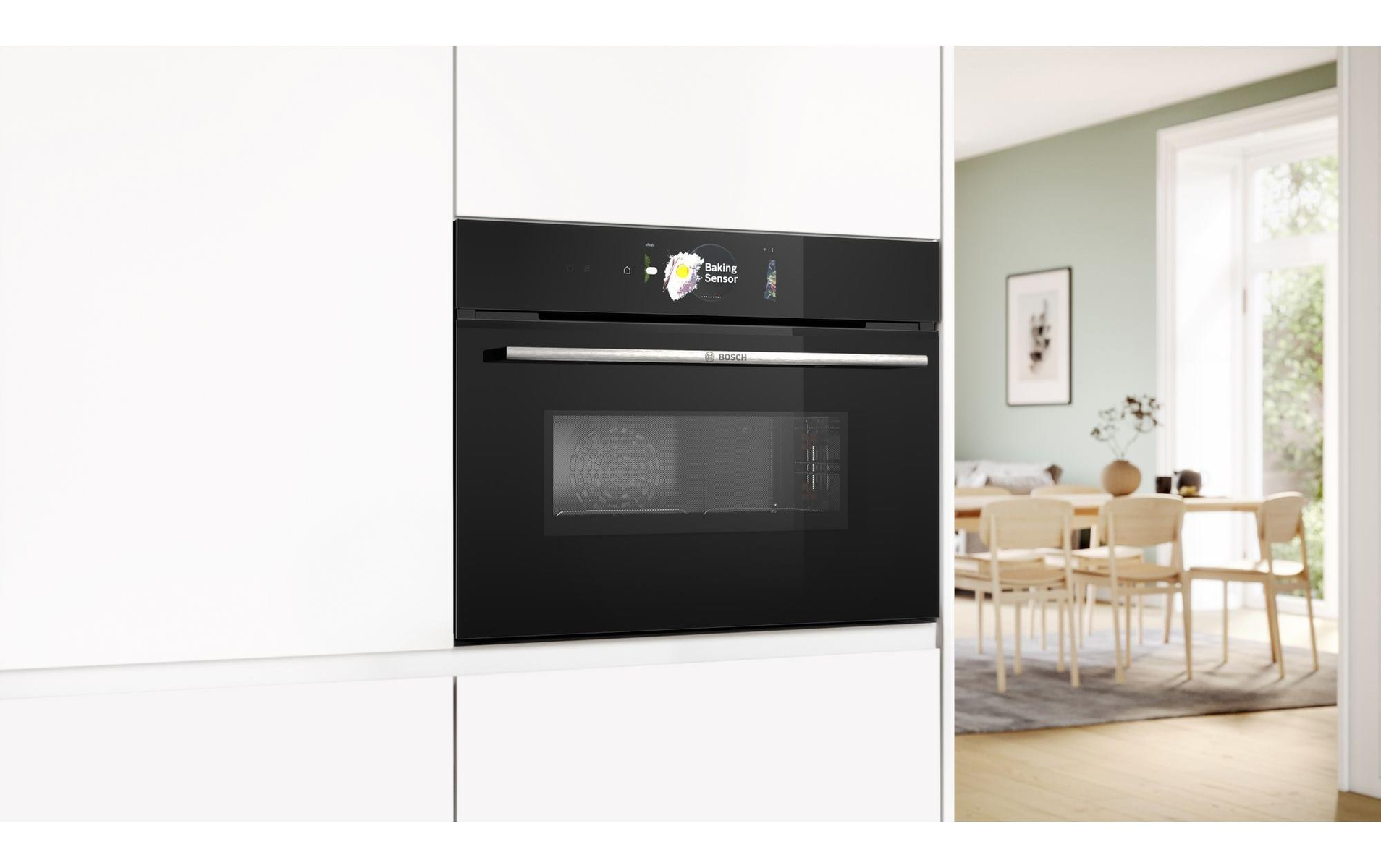 Forno a incasso nero in una cucina bianca. Un display mostra 'Baking Sensor'.