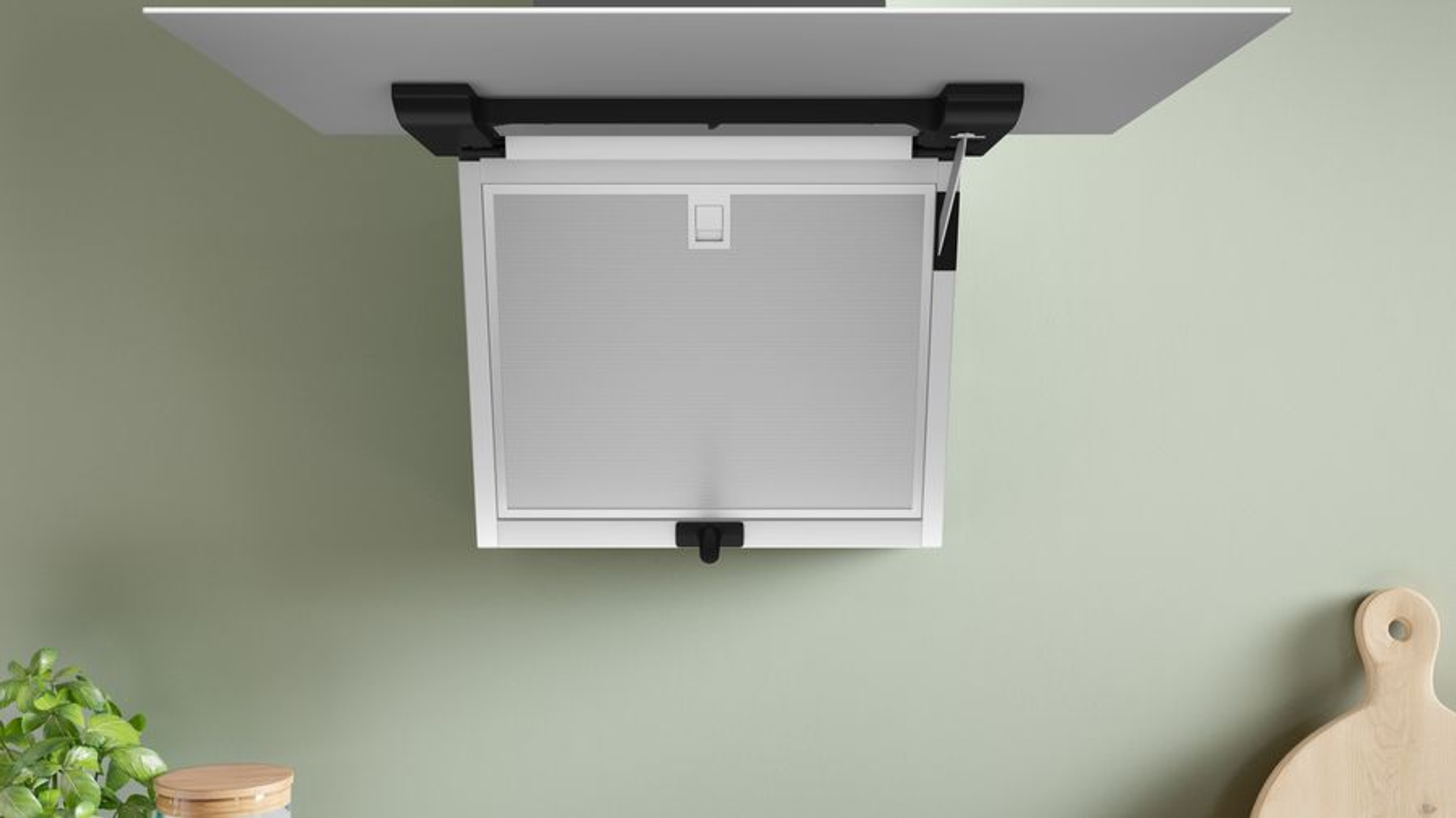 Extractor de cocina, blanco, montado en el techo. Fondo de pared verde. Tabla de cortar de madera.