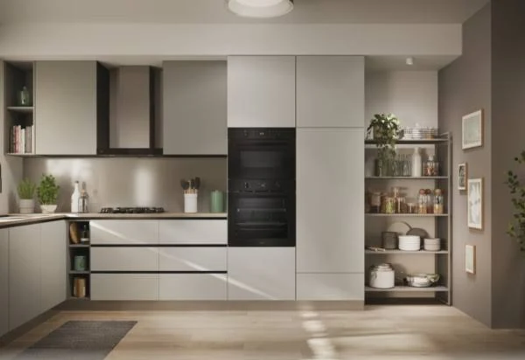 Interior de cocina moderna con armarios grises, horno y estanterías abiertas con plantas.