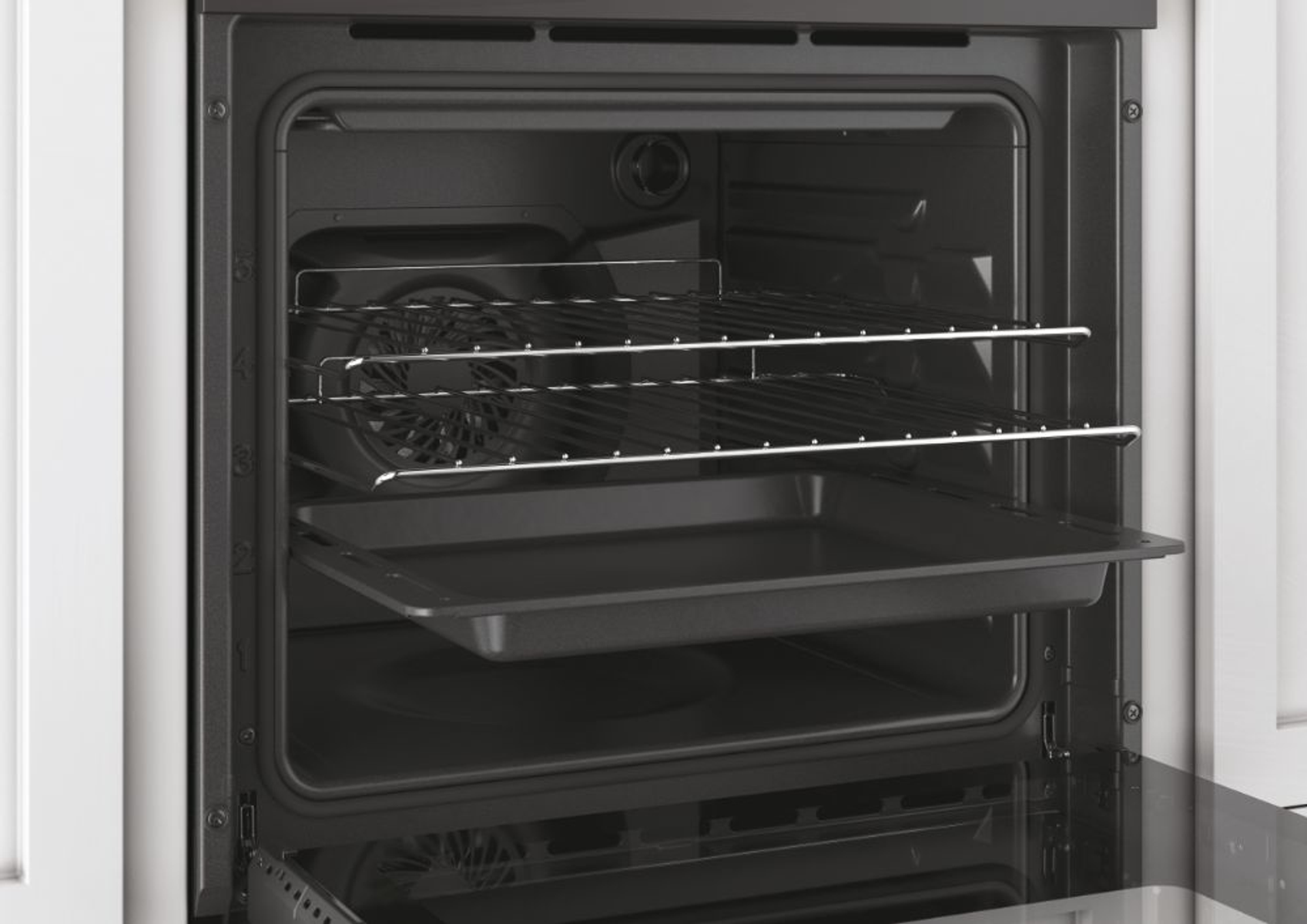 Interno di un forno con vassoio e ripiani. Una ventola sul retro. La porta è aperta.