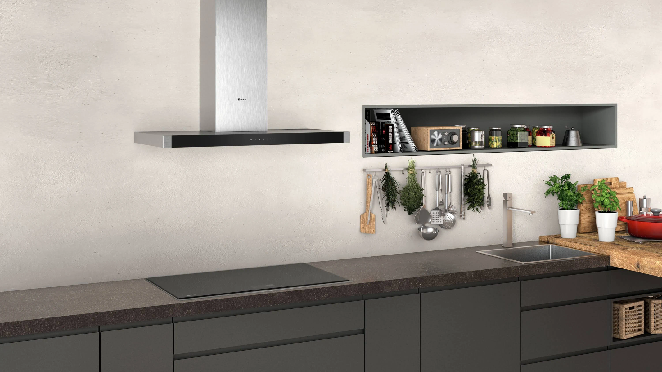 A kitchen scene with a stainless steel range hood above a black stovetop. Shelves with items are visible.