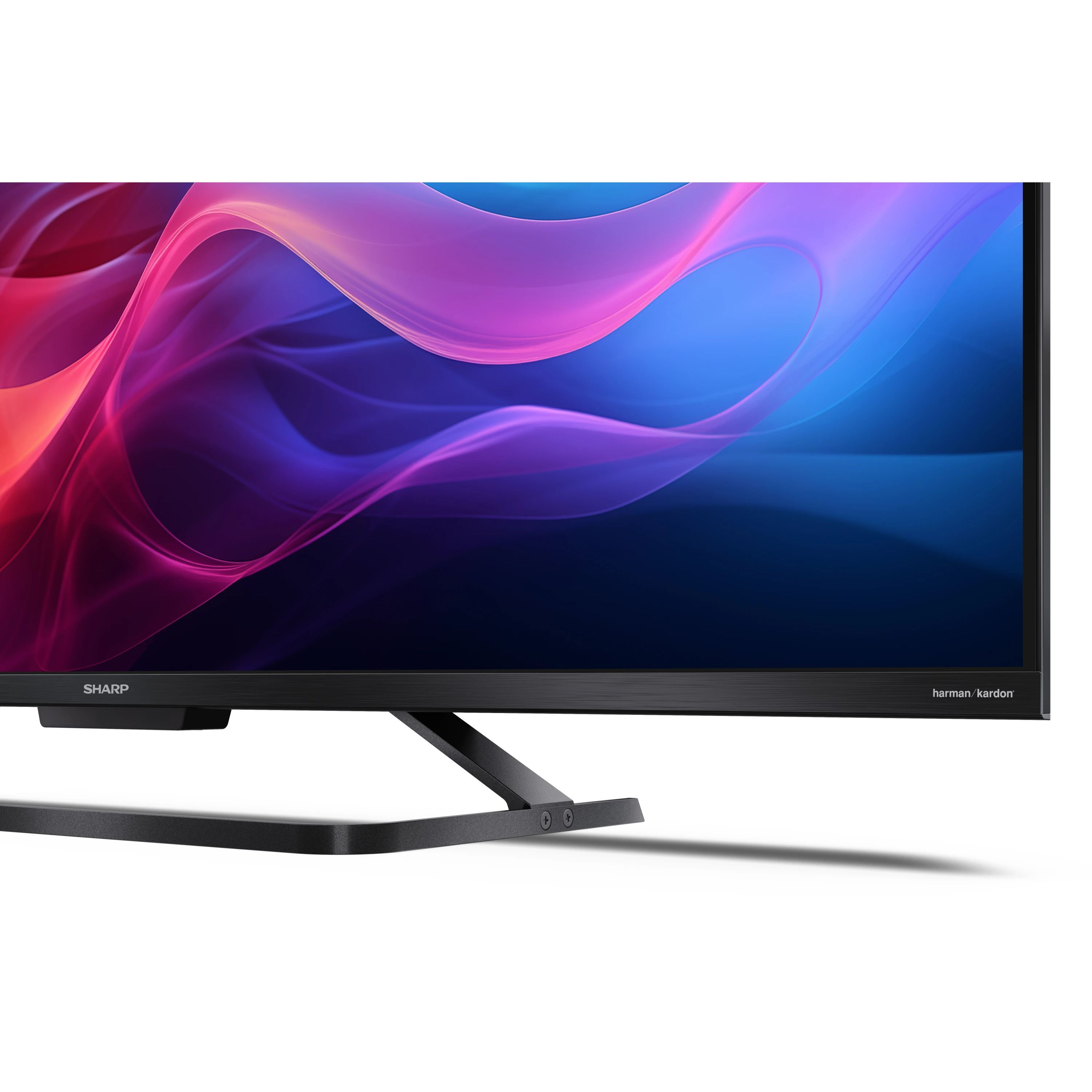 Un téléviseur Sharp affichant une image abstraite colorée, avec un pied noir et le logo harman/kardon.