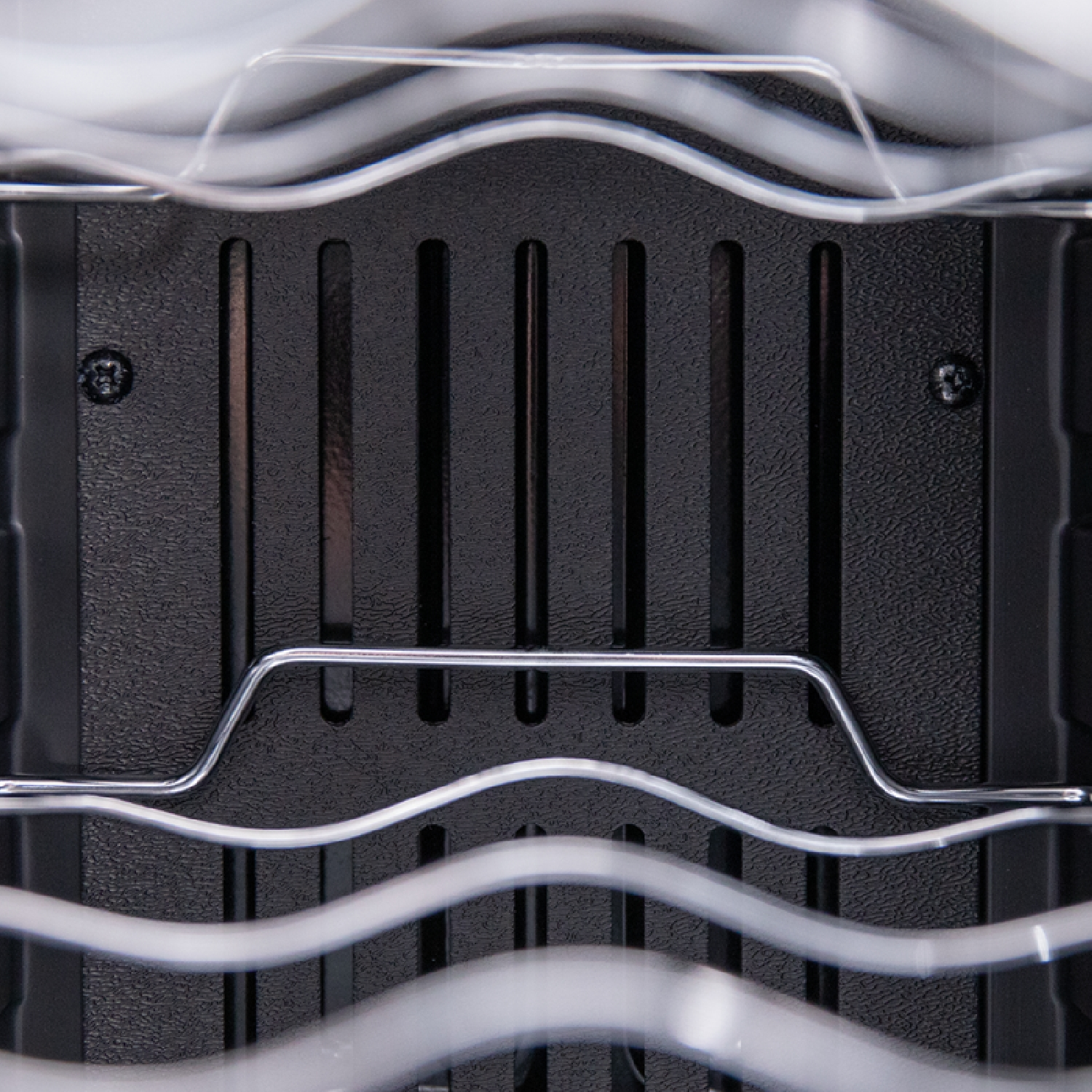 Un primo piano della parte posteriore di un case per PC nero, con un rack metallico e un po' di plastica trasparente.