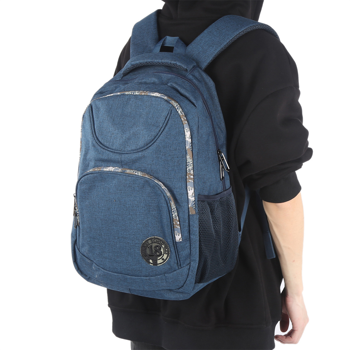 Blauer Jeans-Rucksack, getragen von einer Person in einem schwarzen Hoodie.