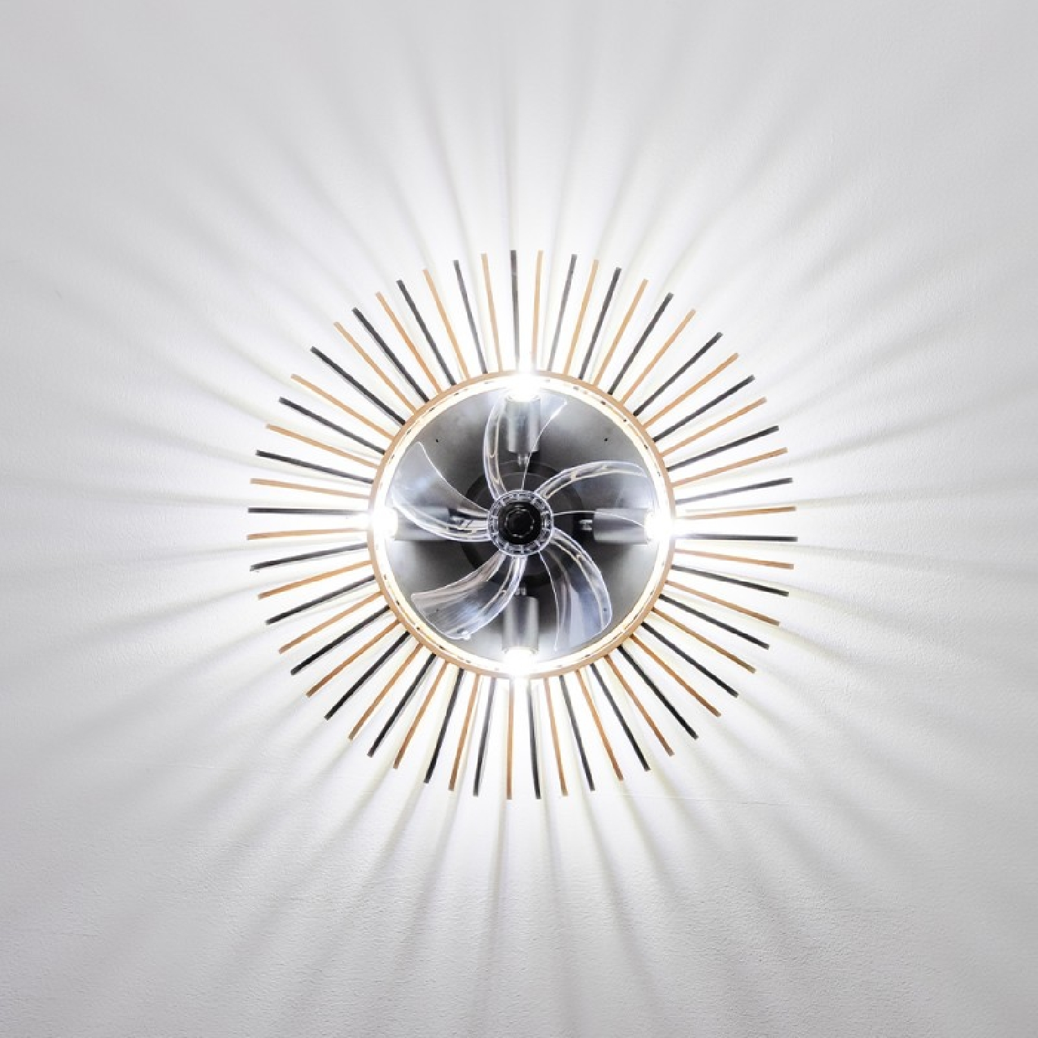 Ceiling fan with lights. Blades are transparent. Circular design with light rays.