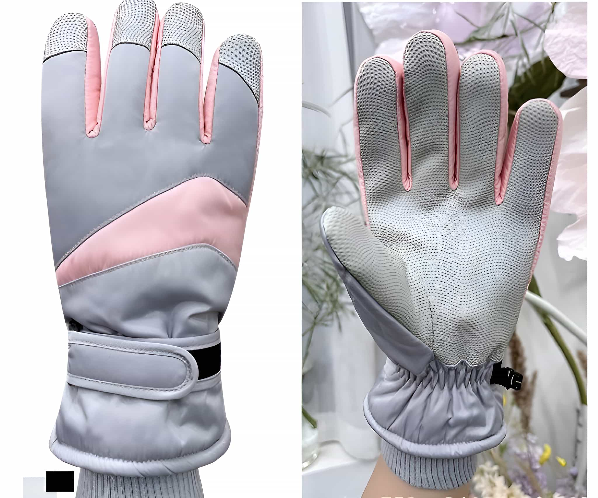 Zwei Handschuhe, grau mit rosa Akzenten, auf einer weißen Oberfläche platziert.