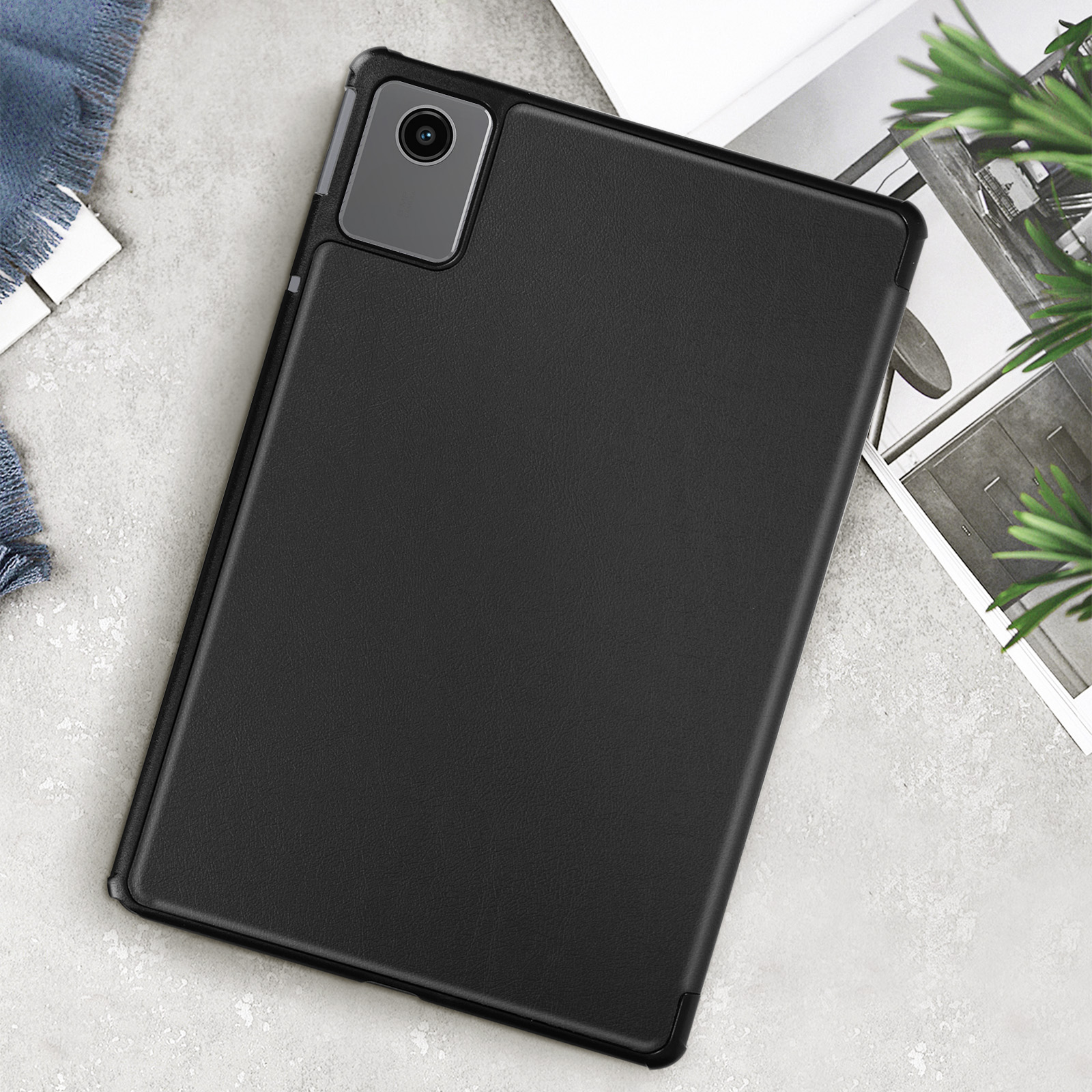 Custodia nera per tablet con ritaglio per fotocamera, su una superficie strutturata.